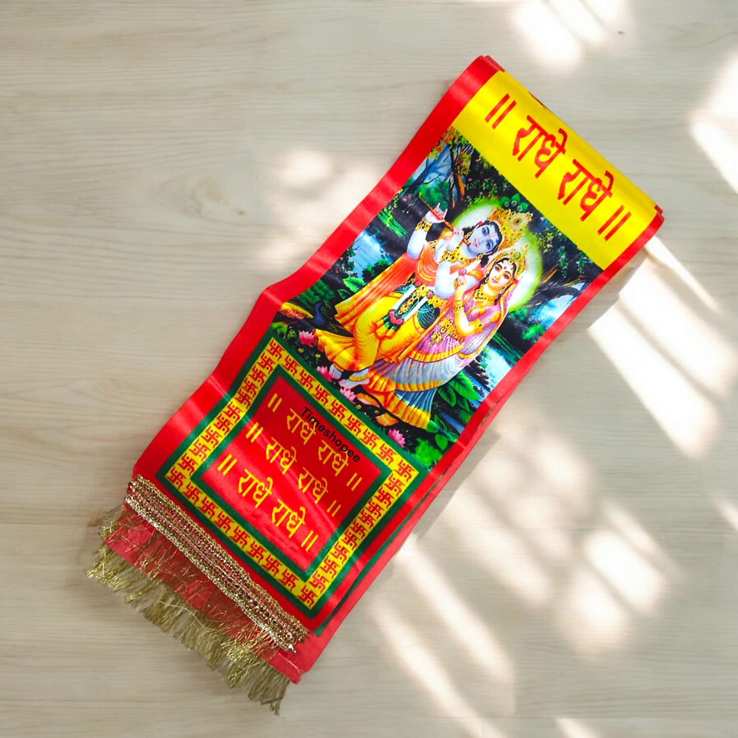 A vibrant satin stole with "Radhe Radhe" print, perfect for pooja and kirtan.
