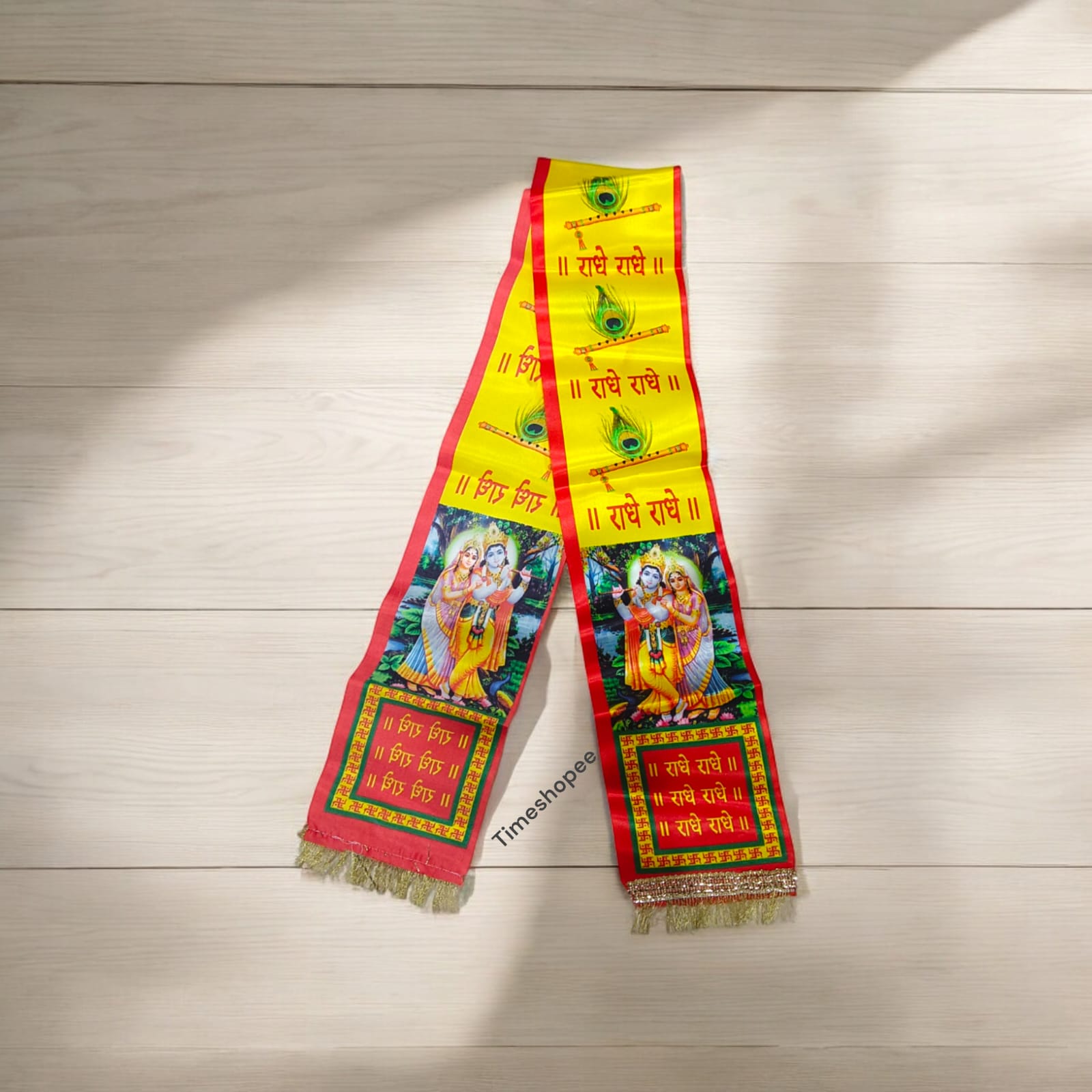 A vibrant satin stole with "Radhe Radhe" print, perfect for pooja and kirtan.
