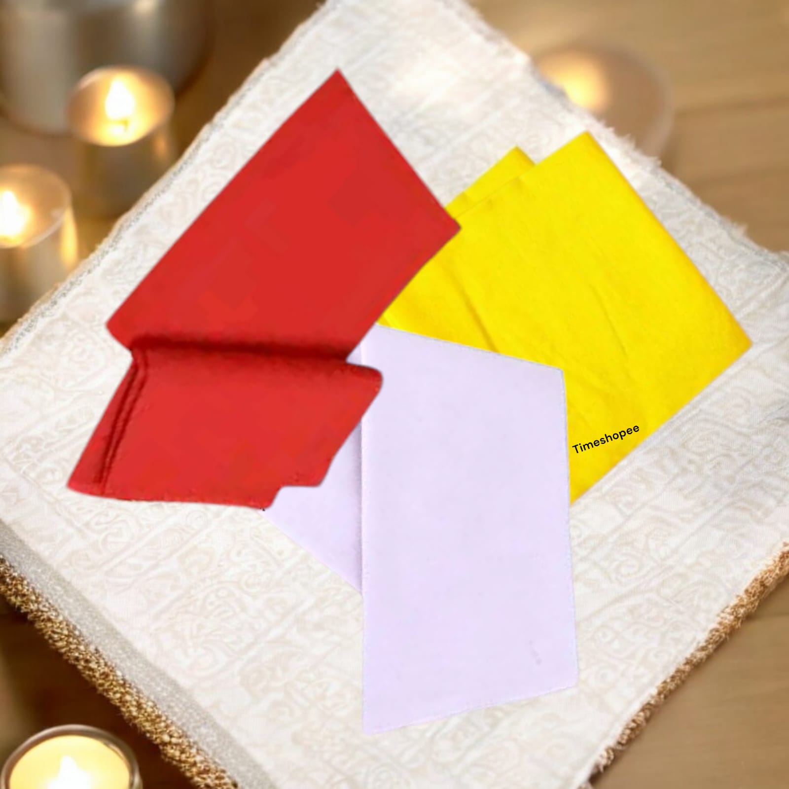 A vibrant set of three 1.25-meter pooja cloths in red, yellow, and white, symbolizing strength, prosperity, and purity for worship.