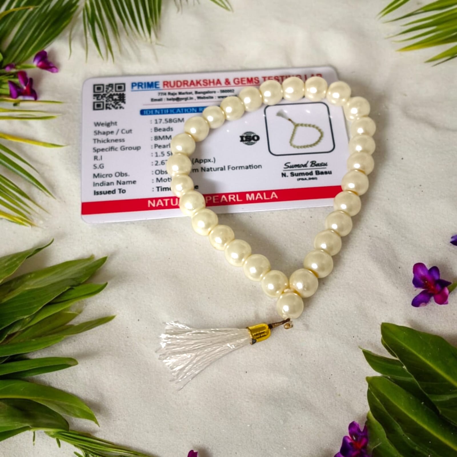 An elegant Pearl Mala featuring 27+1 original 8MM lab-certified pearls, arranged neatly for display.