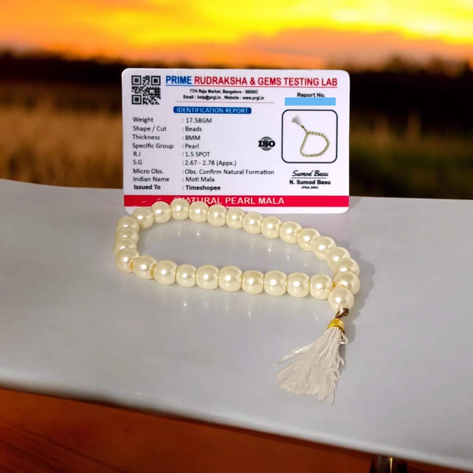 An elegant Pearl Mala featuring 27+1 original 8MM lab-certified pearls, arranged neatly for display.