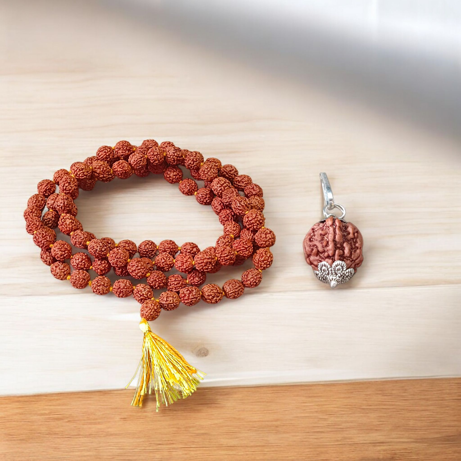 Authentic 5 Mukhi Rudraksha Mala and Pendant Combo placed on a white background with sacred thread and spiritual packaging