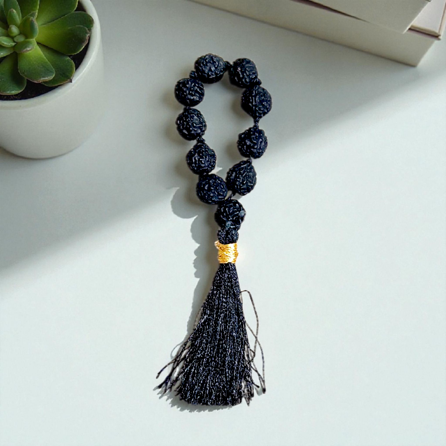 Black 5 Mukhi Rudraksha Mala with 108+1 natural beads, used for meditation and mantra chanting, displayed on a white background