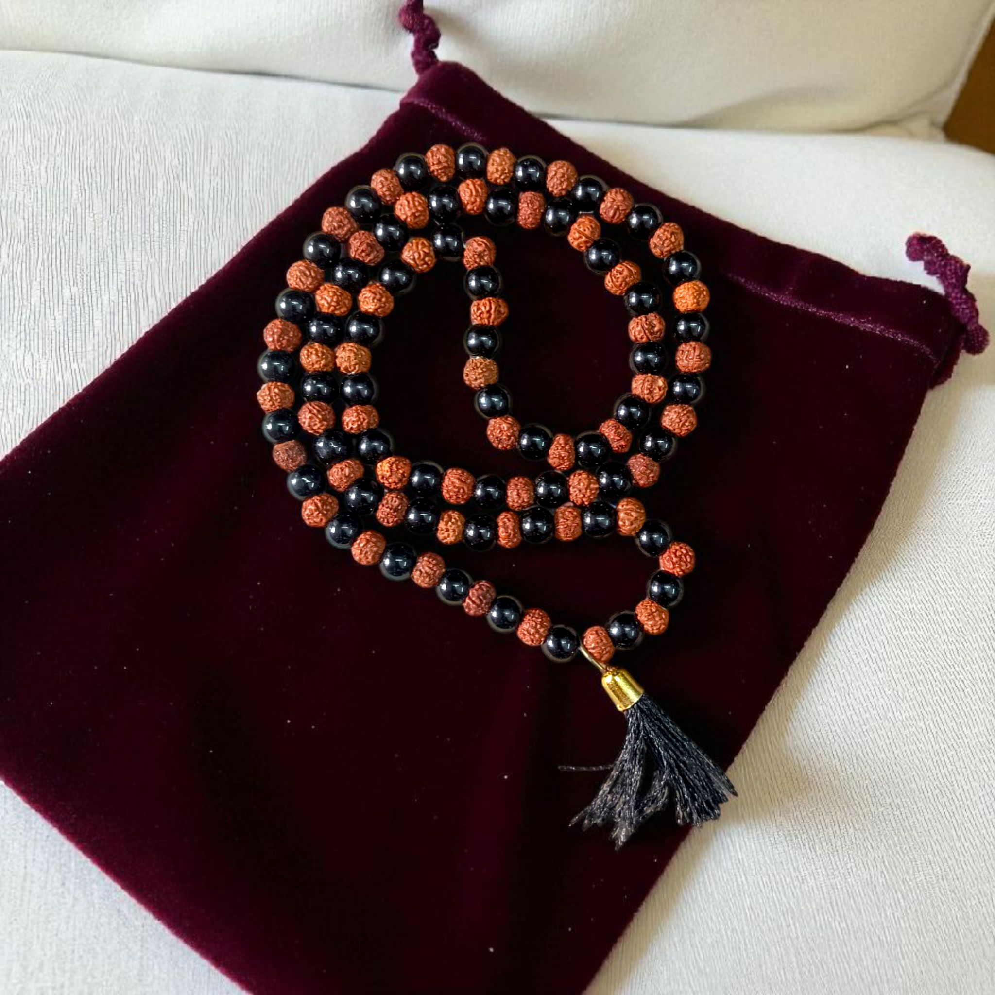 A Black Agate and Rudraksha Mala with 108+1 beads, each bead 6MM in size. Perfect for mantra chanting and daily wear, the mala offers spiritual energy and protection