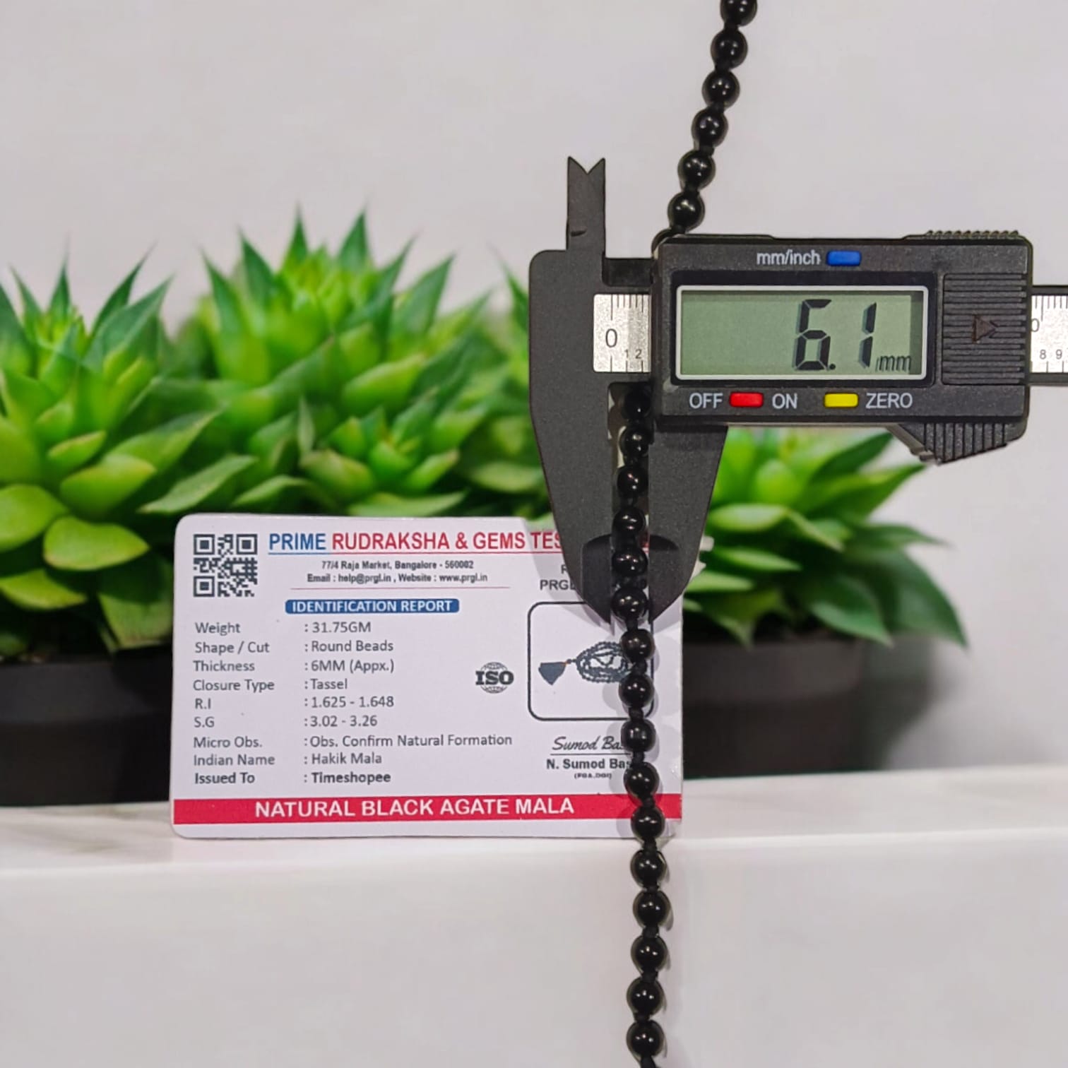 Black Hakik Mala with 6MM beads, 108+1 beads, lab-certified for authenticity, shown in a close-up view.