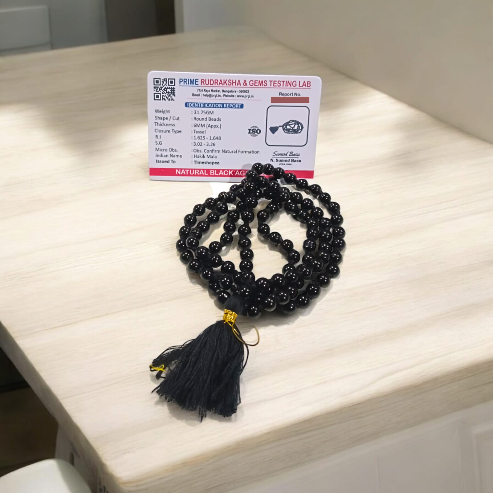 Black Hakik Mala with 6MM beads, 108+1 beads, lab-certified for authenticity, shown in a close-up view.