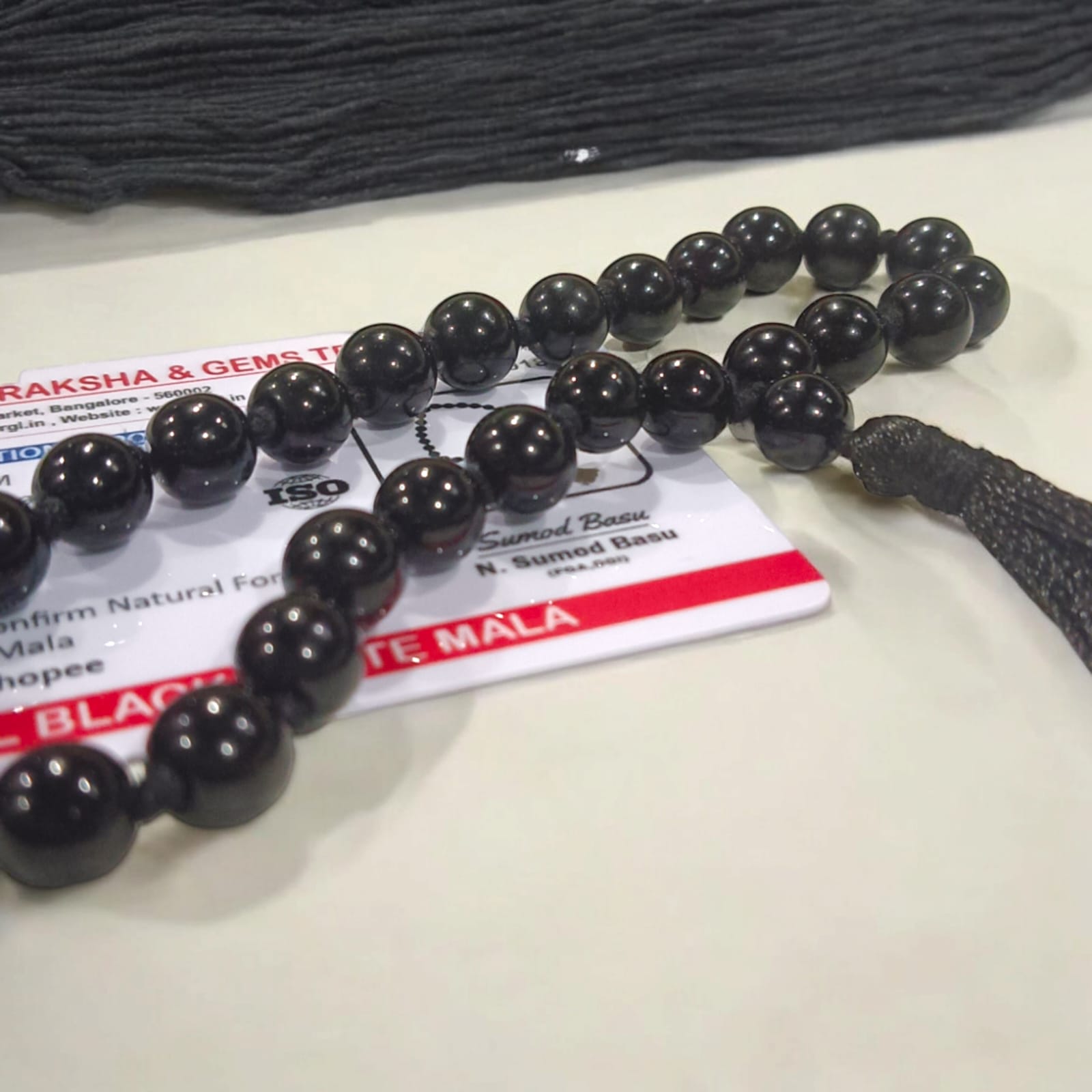 Black Hakik Mala with 8MM beads and 27+1 bead count, lab-certified for authenticity, shown in a convenient, easy-to-carry design.