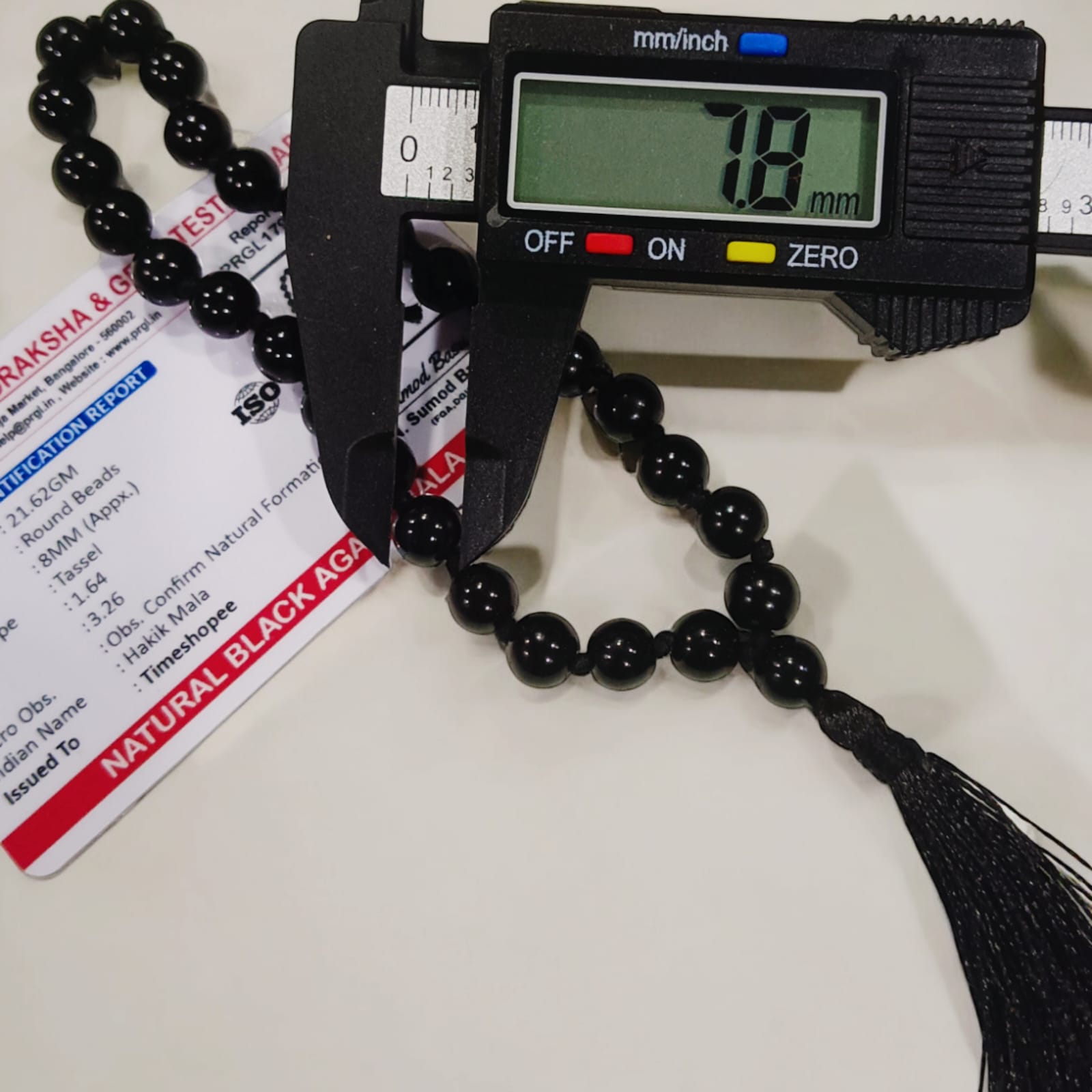 Black Hakik Mala with 8MM beads and 27+1 bead count, lab-certified for authenticity, shown in a convenient, easy-to-carry design.