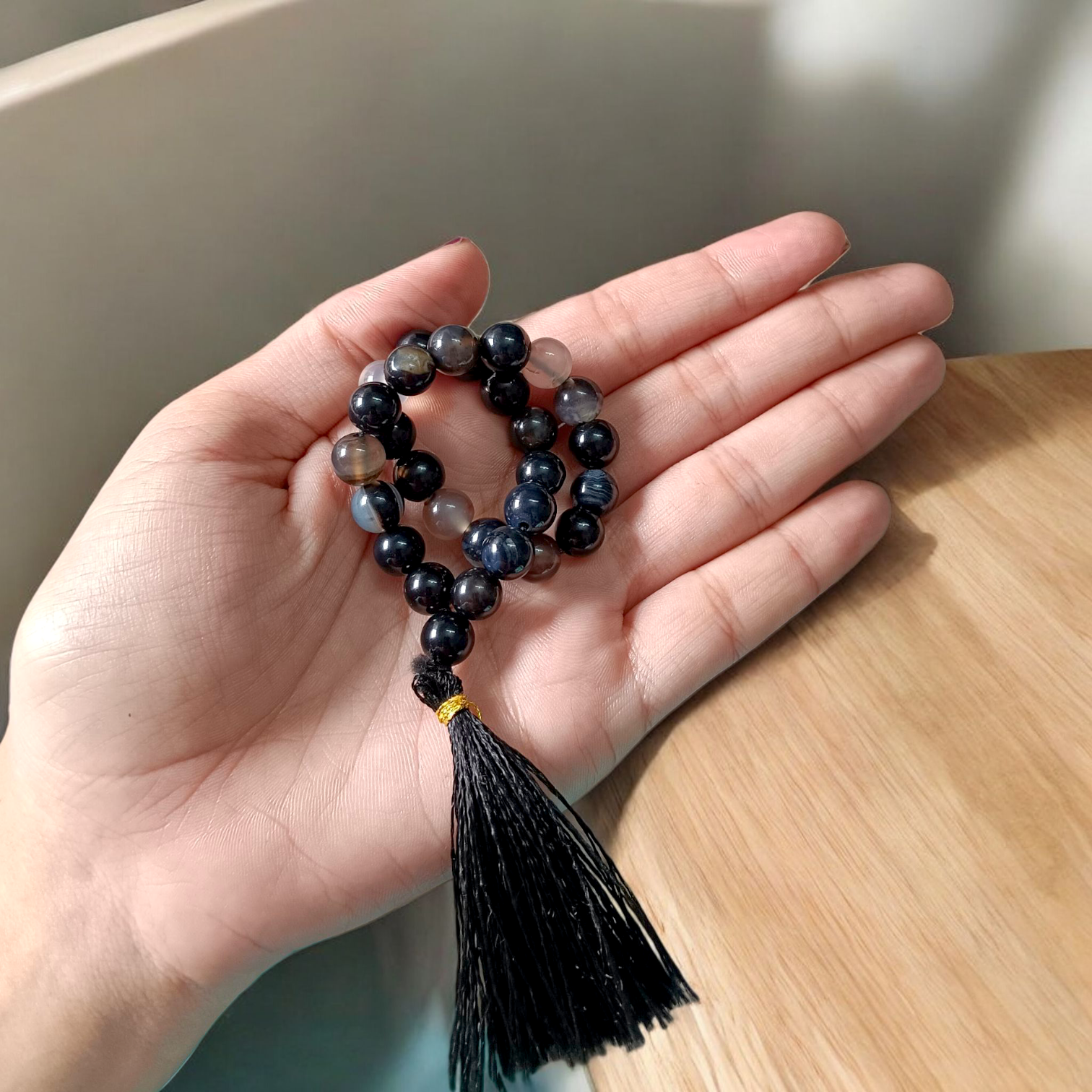 Close-up image of Natural Sulemani Hakik Mala (Black Agate) with 27+1 round beads, 8MM in size, used for Japa, meditation, and daily spiritual protection