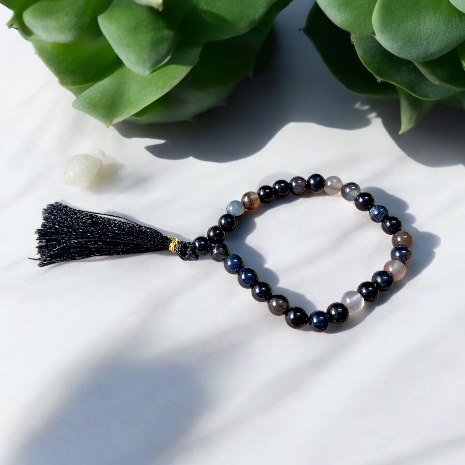 Close-up image of Natural Sulemani Hakik Mala (Black Agate) with 27+1 round beads, 8MM in size, used for Japa, meditation, and daily spiritual protection