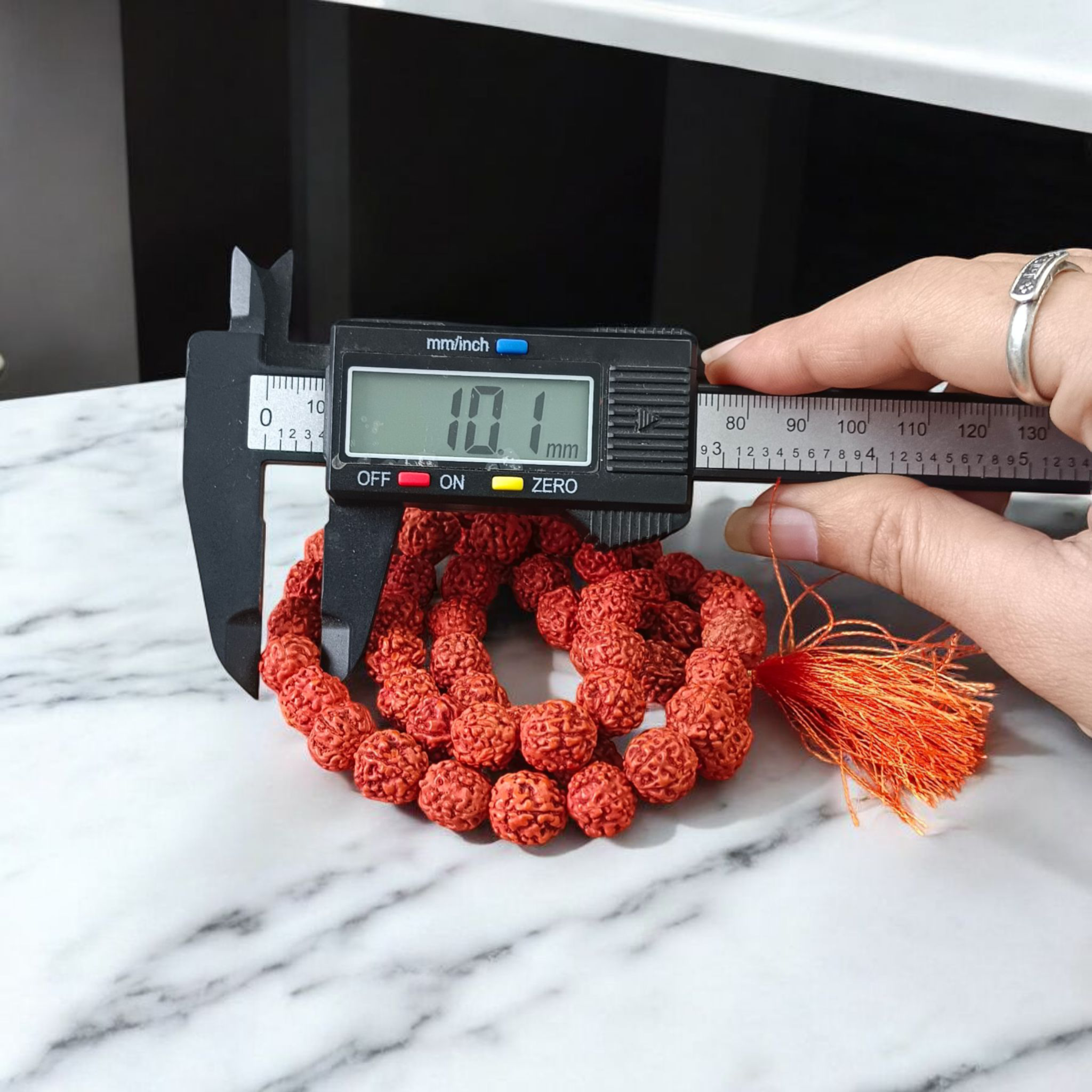 Close-up image of a 5 Mukhi Rudraksha Mala with 54+1 natural brown beads (10-11mm), arranged for Jaap and spiritual use