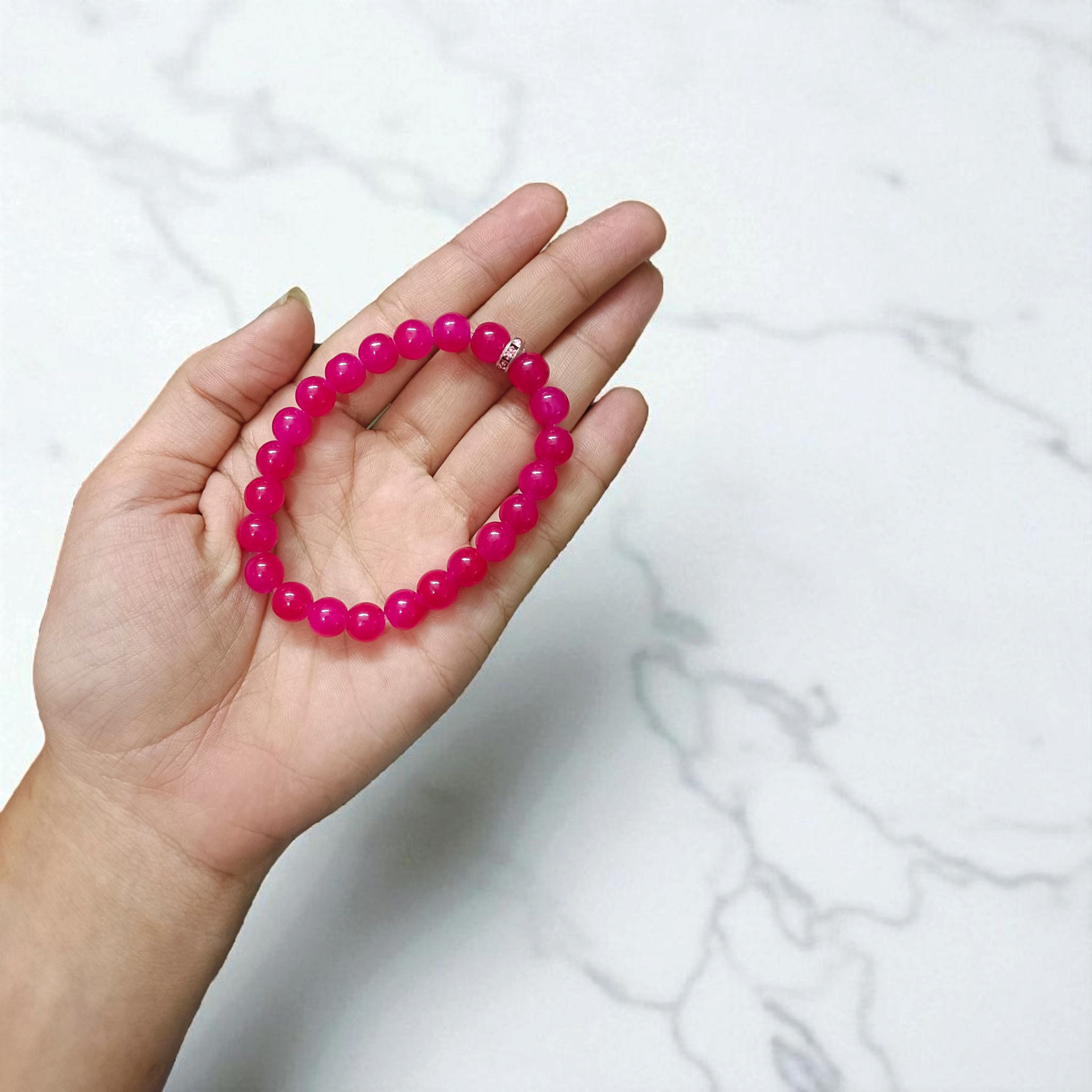 Close-up image of a stretchable bracelet made of natural pink agate (pink hakik) 8mm beads, designed for spiritual and daily wear