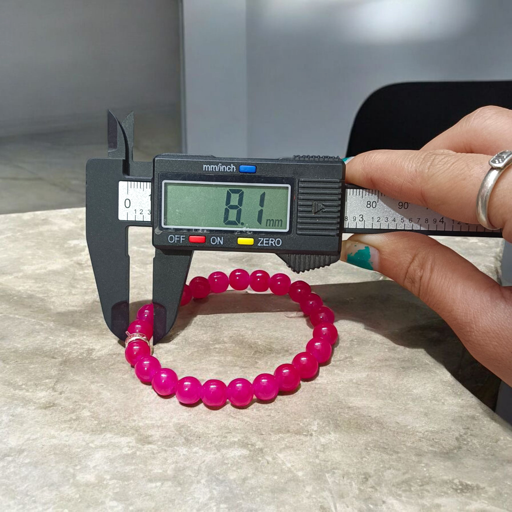 Close-up image of a stretchable bracelet made of natural pink agate (pink hakik) 8mm beads, designed for spiritual and daily wear