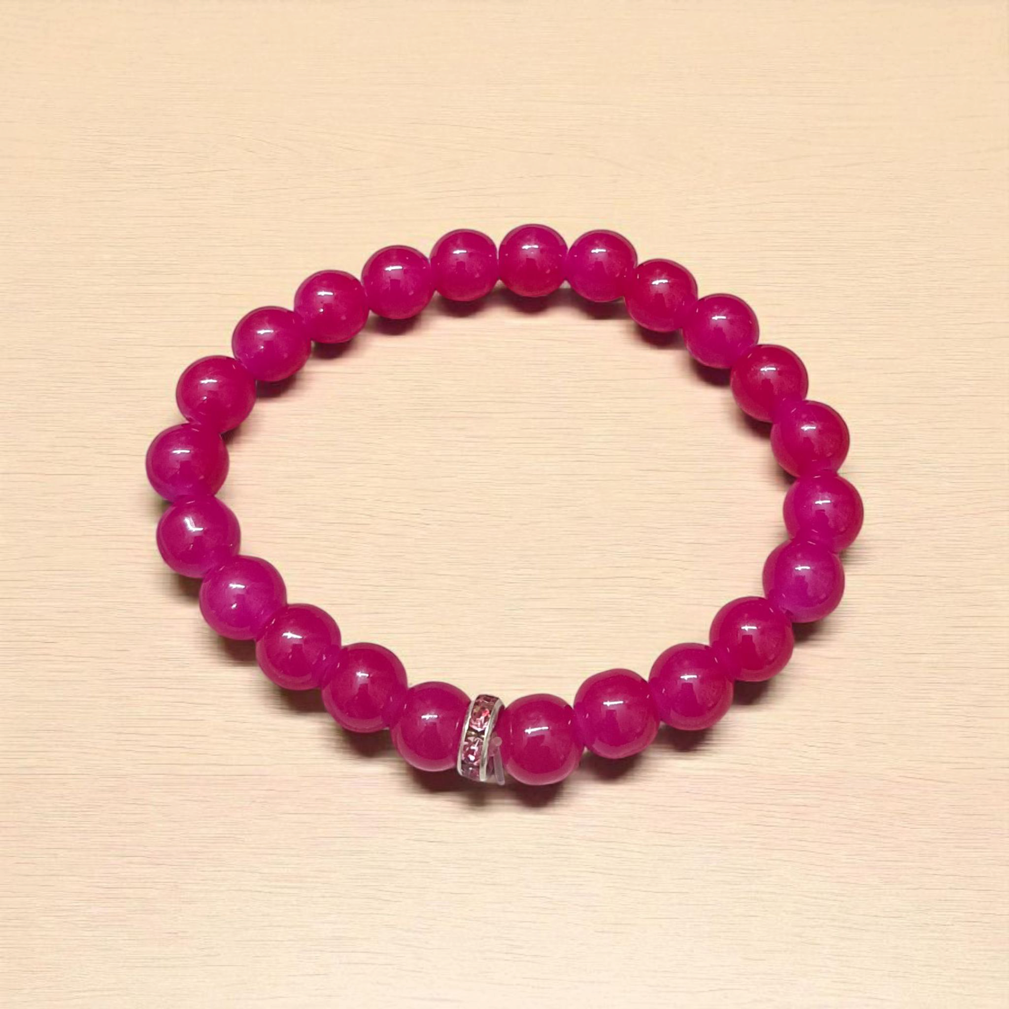 Close-up image of a stretchable bracelet made of natural pink agate (pink hakik) 8mm beads, designed for spiritual and daily wear
