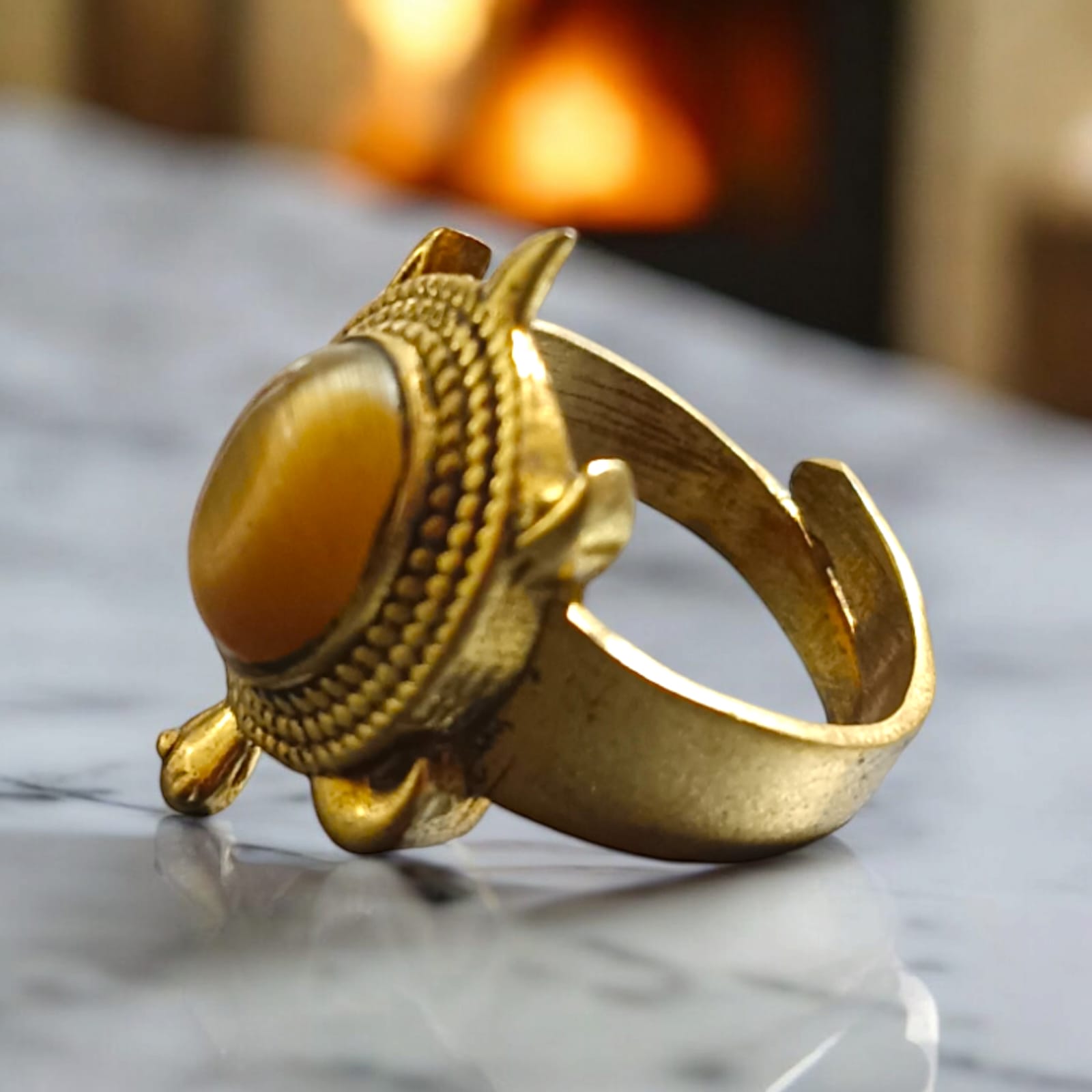 Close-up image of the Kachua Tiger Eye Ring, featuring a brown and gold Tiger Eye gemstone set in a tortoise-shaped design, made from Ashtdhatu. The ring is adjustable and unisex.