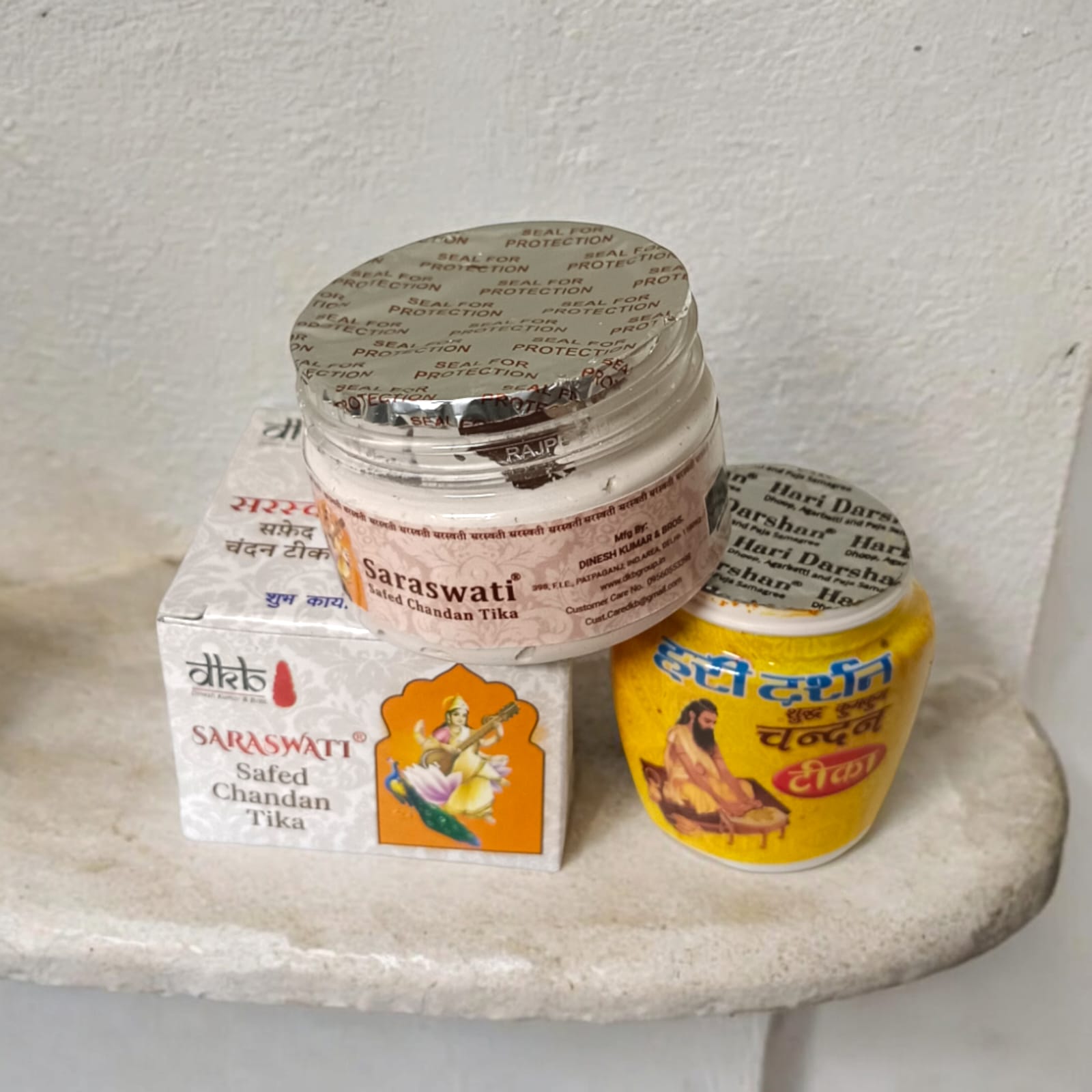 Combo of White and Yellow Liquid Chandan Tilak bottles, used for forehead application in religious rituals, pack of 2, easy to apply.