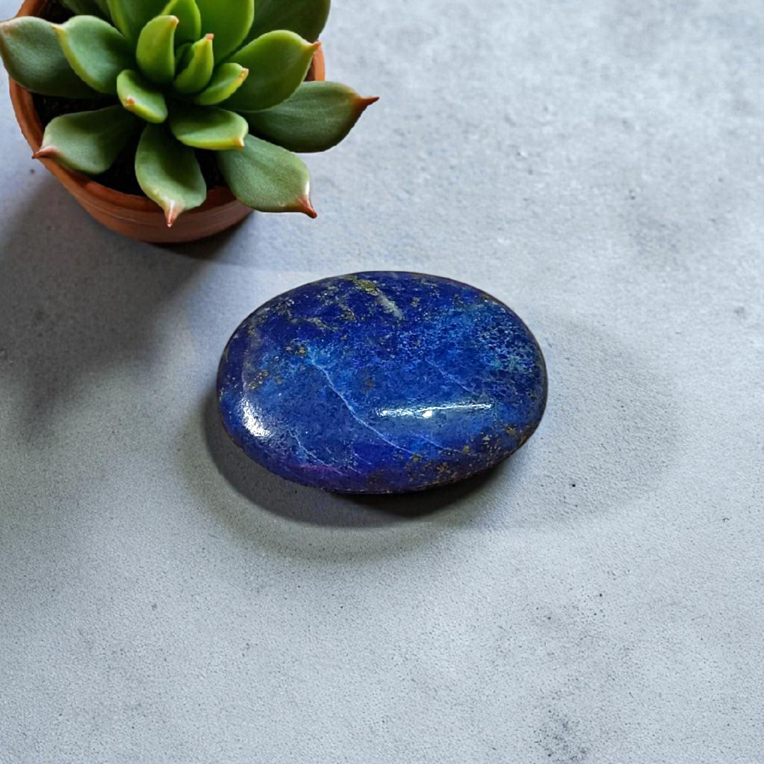 Deep blue Lapis Lazuli stone with golden flecks, used for mental clarity and emotional healing