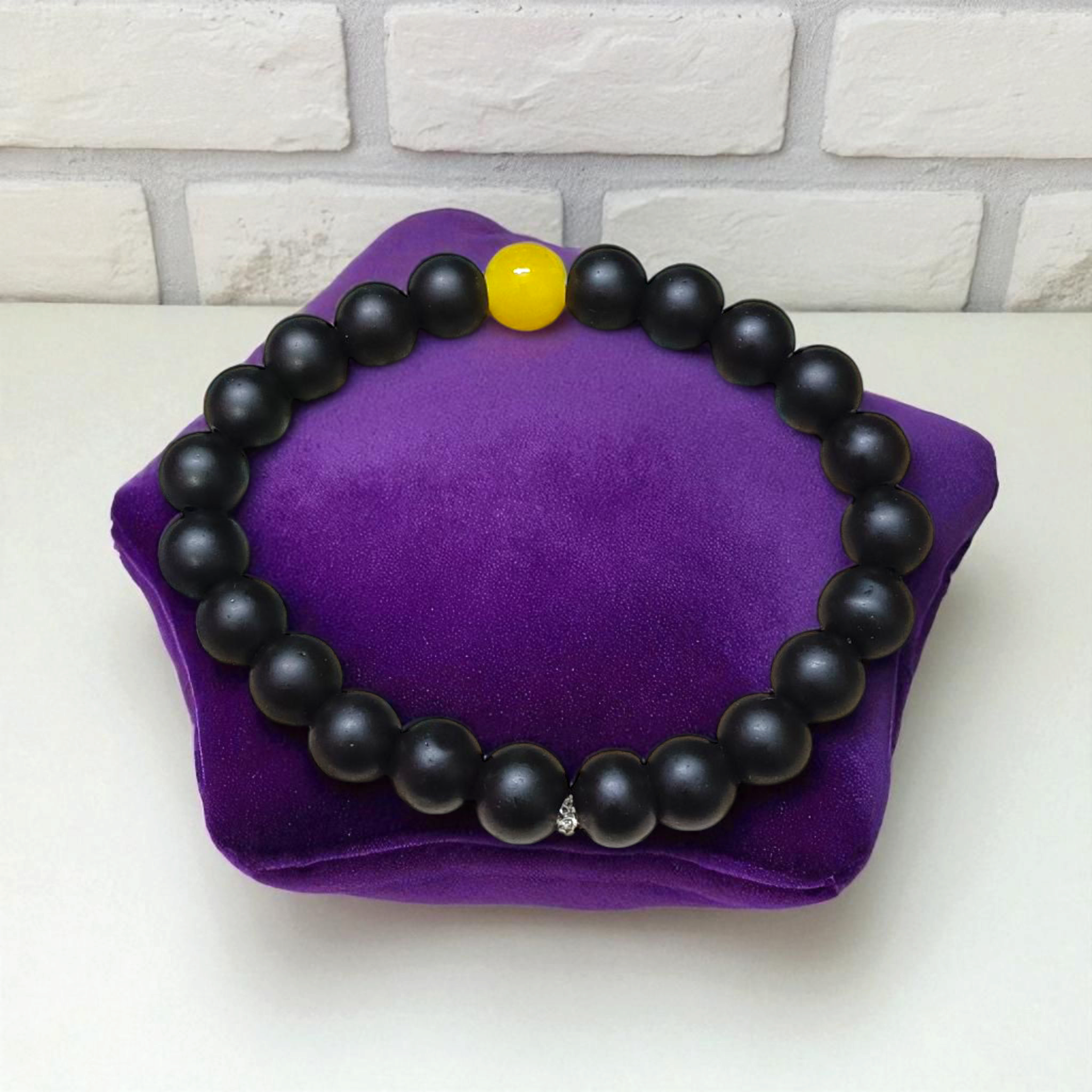 Ebony & Yellow Agate Bracelet with 8mm natural beads, stretchable unisex design placed on a soft white background