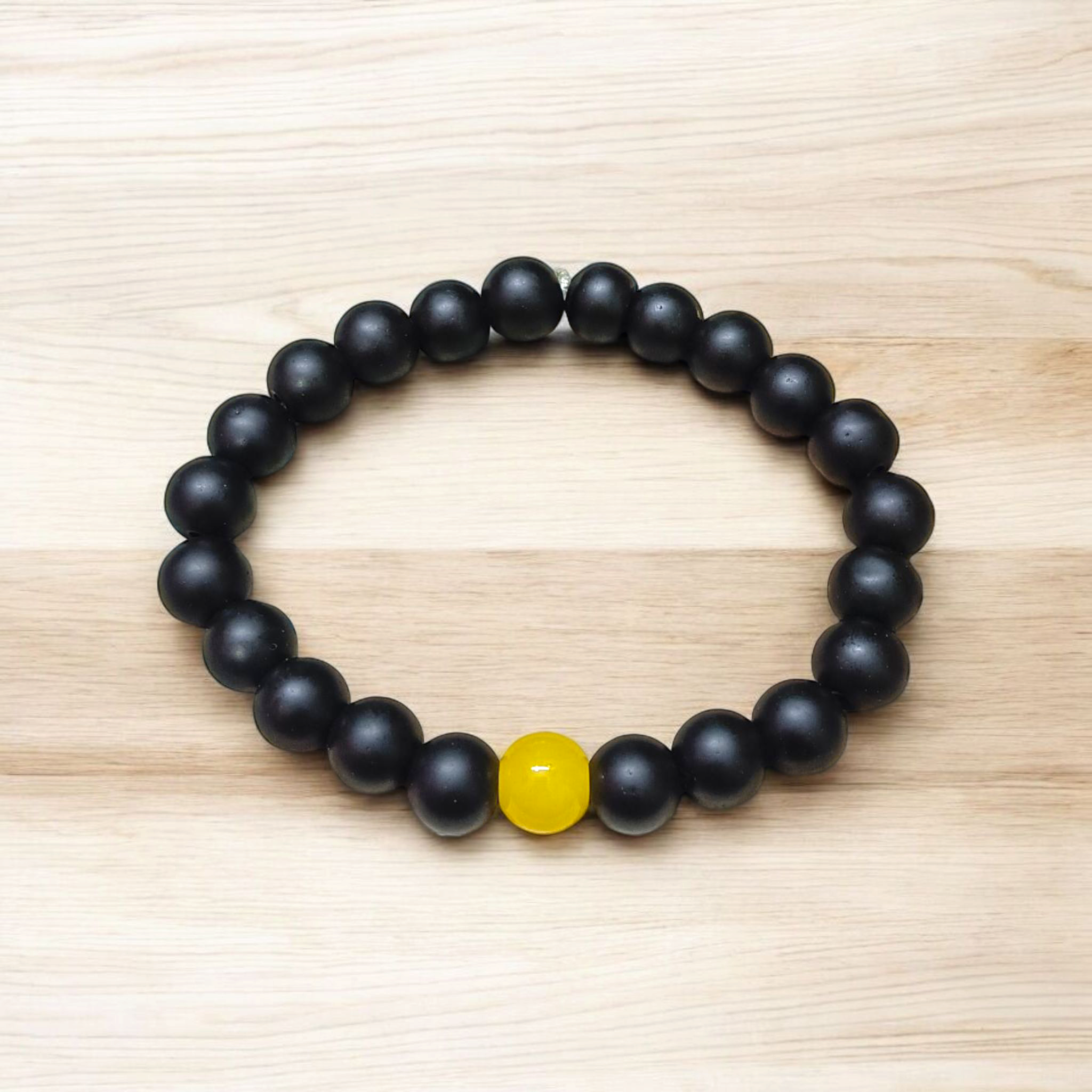 Ebony & Yellow Agate Bracelet with 8mm natural beads, stretchable unisex design placed on a soft white background