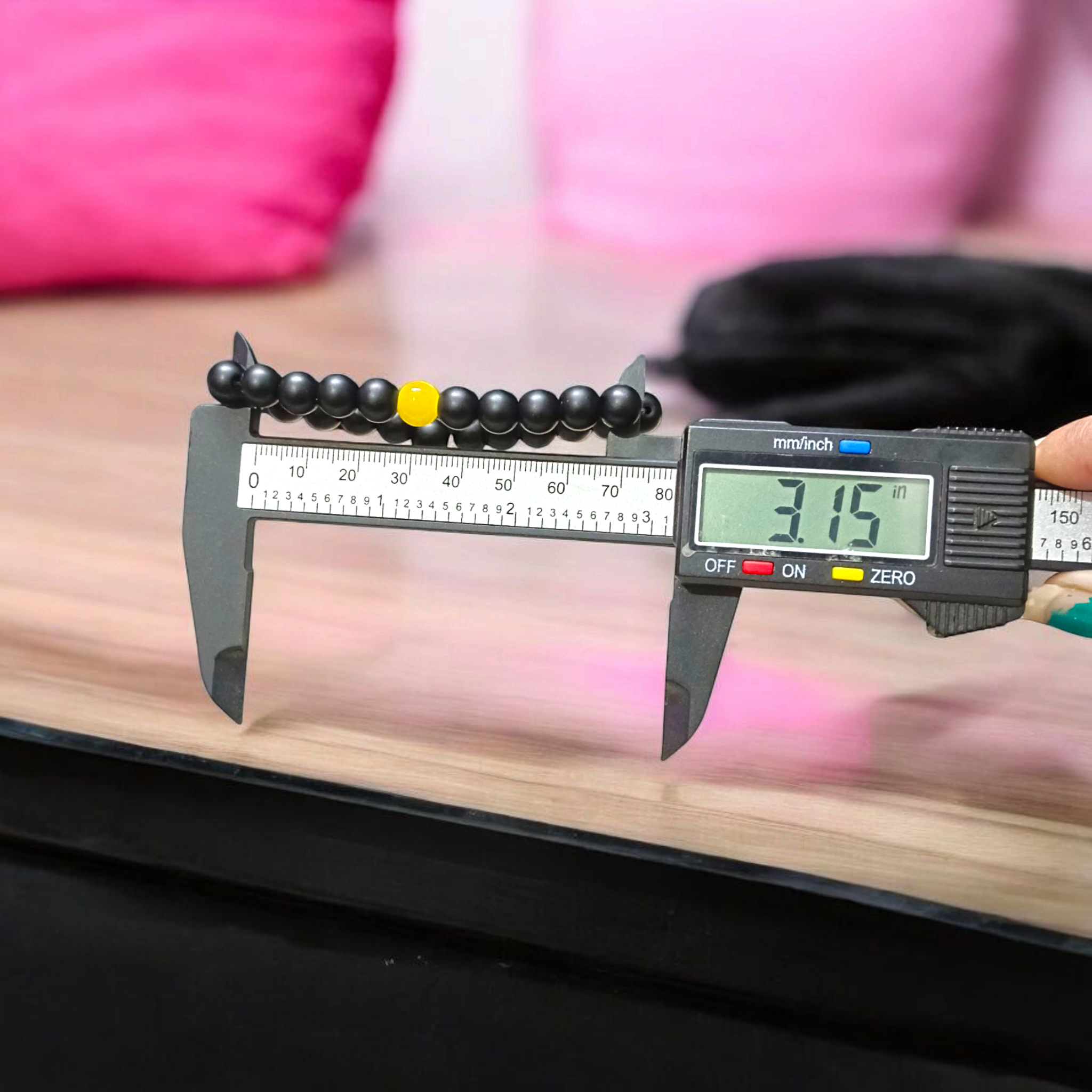 Ebony & Yellow Agate Bracelet with 8mm natural beads, stretchable unisex design placed on a soft white background