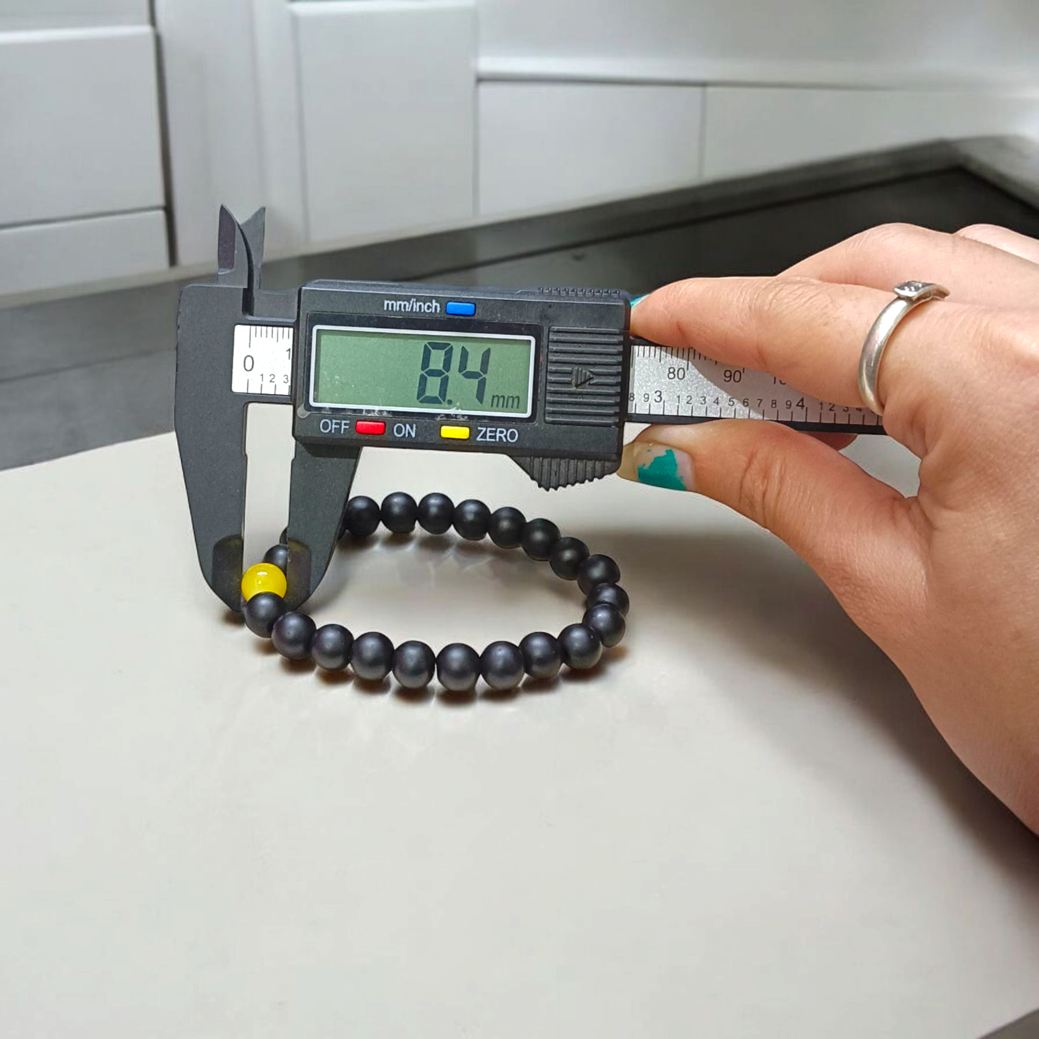 Ebony & Yellow Agate Bracelet with 8mm natural beads, stretchable unisex design placed on a soft white background