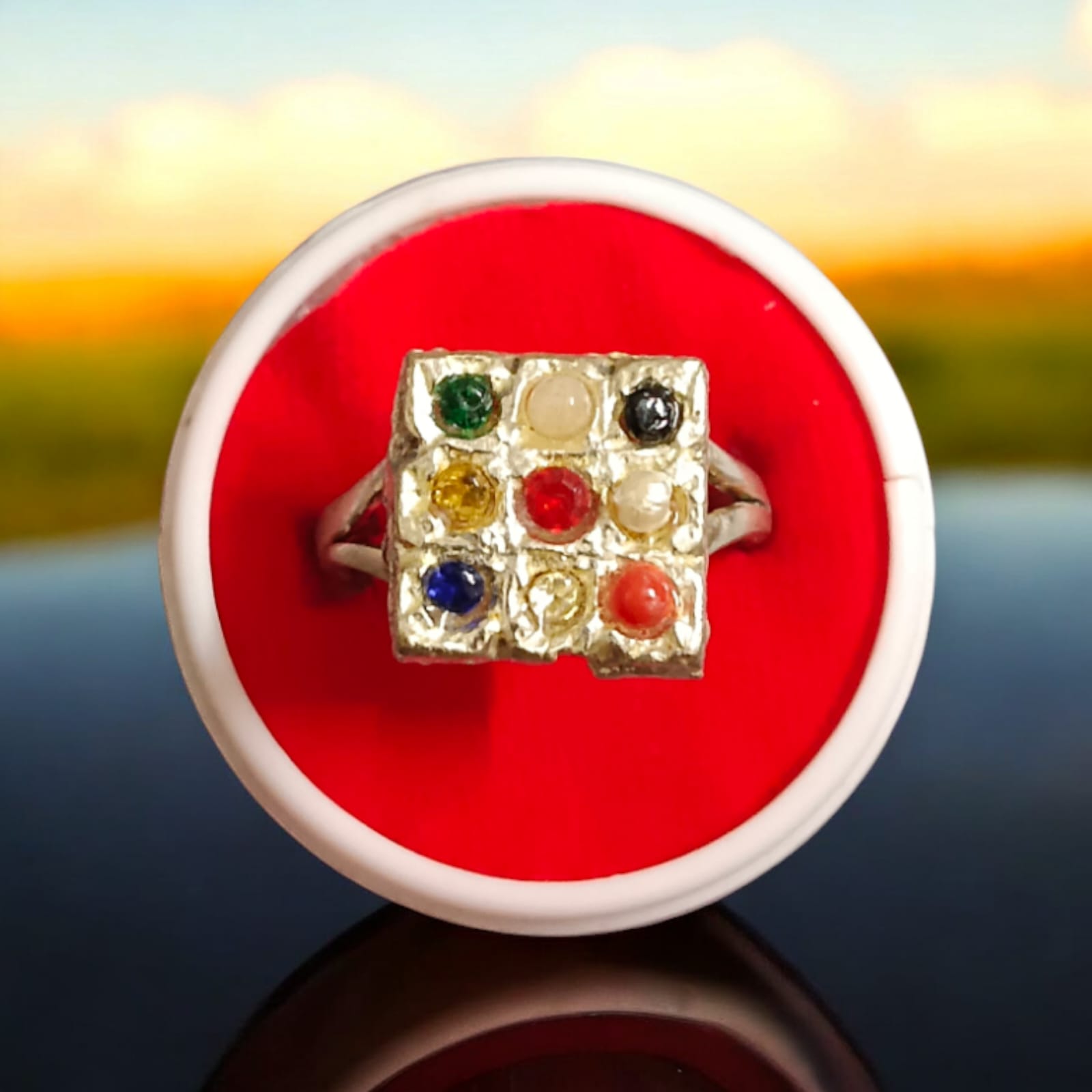 Elegant Navratan ring with a square-shaped design featuring nine vibrant gemstones, available at Timeshopee.