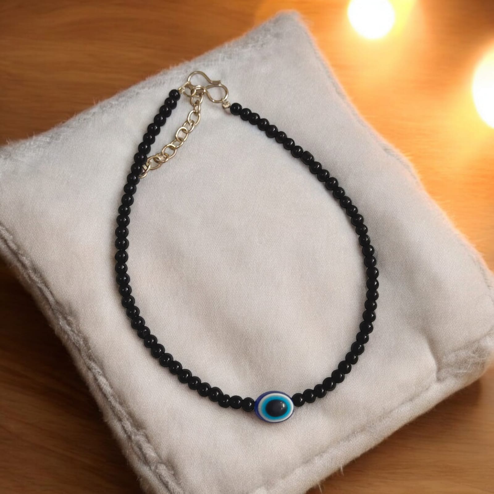Elegant anklet pair with evil eye charm and black beads, designed for women and girls.