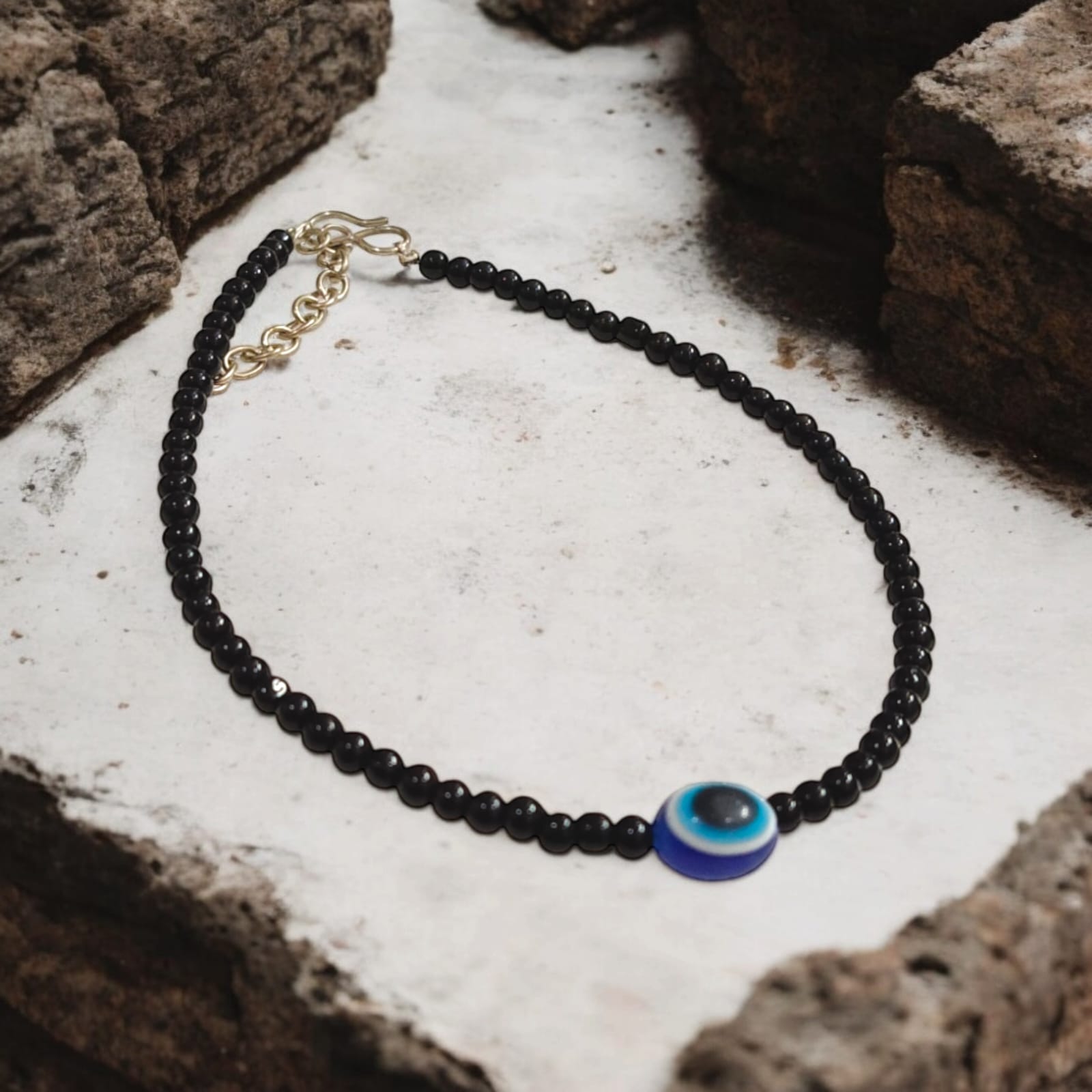Elegant anklet pair with evil eye charm and black beads, designed for women and girls.