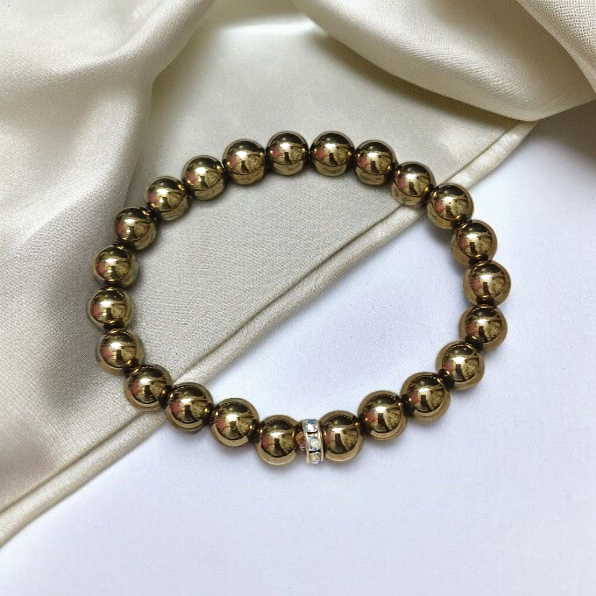 Golden Pyrite Bracelet with 8mm beads, lab-certified, displayed in a circular arrangement with elegant packaging