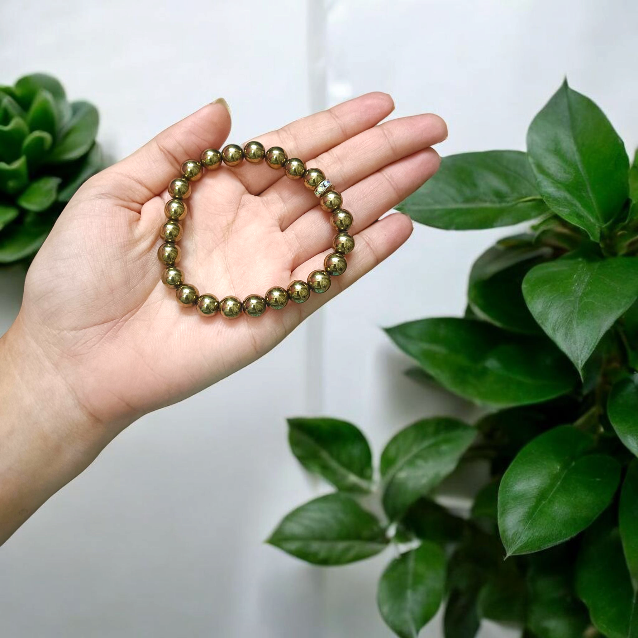 Golden Pyrite Bracelet with 8mm beads, lab-certified, displayed in a circular arrangement with elegant packaging