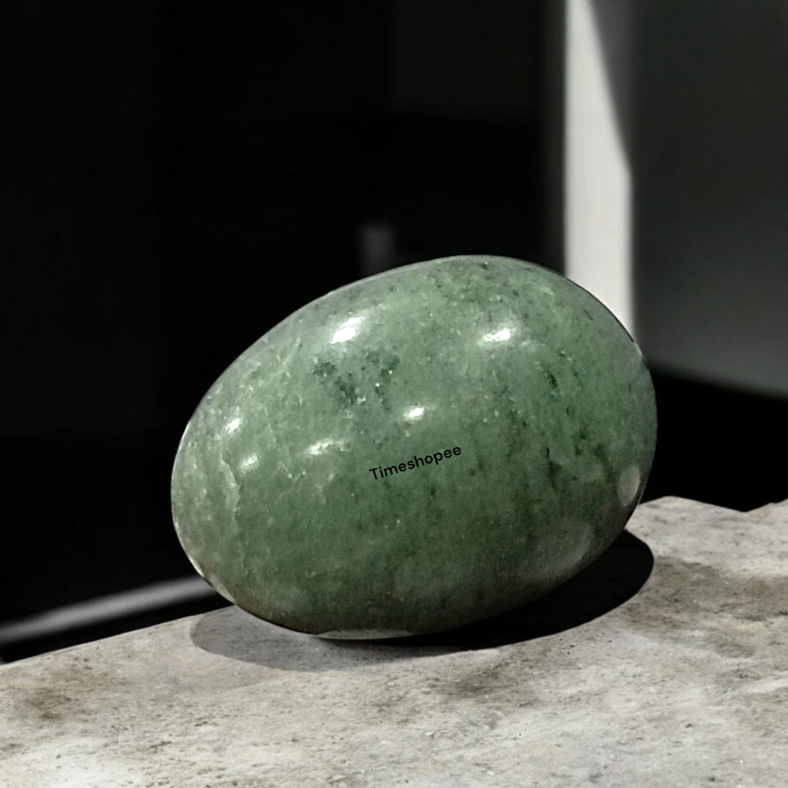 Greenish Black Shivling Stone for Tulsi and temple use, symbolizing stability and divine energy with unique natural patterns.