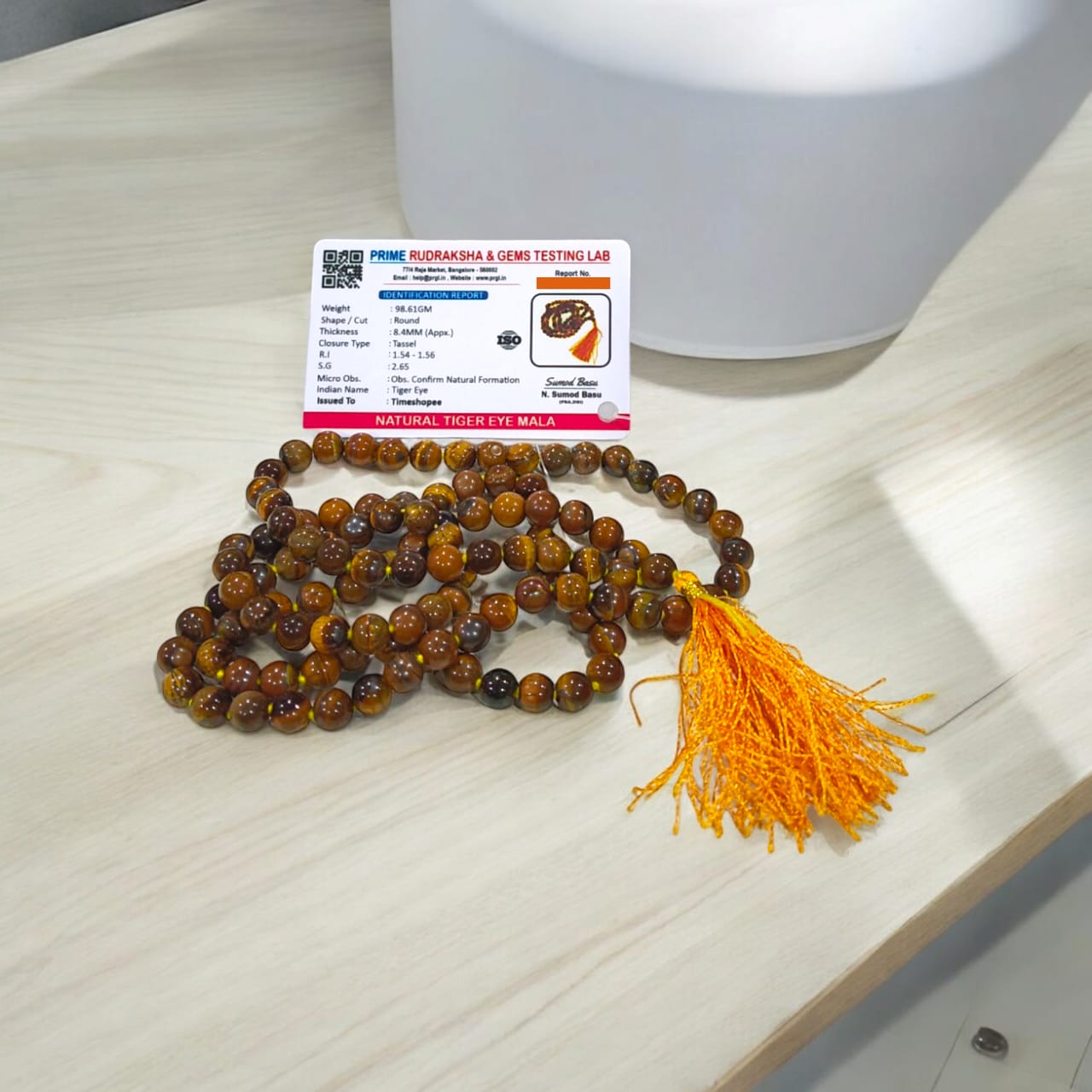 High-quality image of Tiger Eye Mala with natural golden-brown stone beads arranged in a traditional mala style