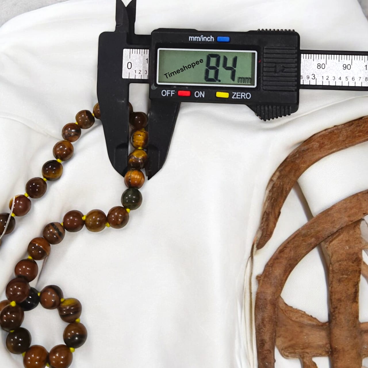 High-quality image of Tiger Eye Mala with natural golden-brown stone beads arranged in a traditional mala style