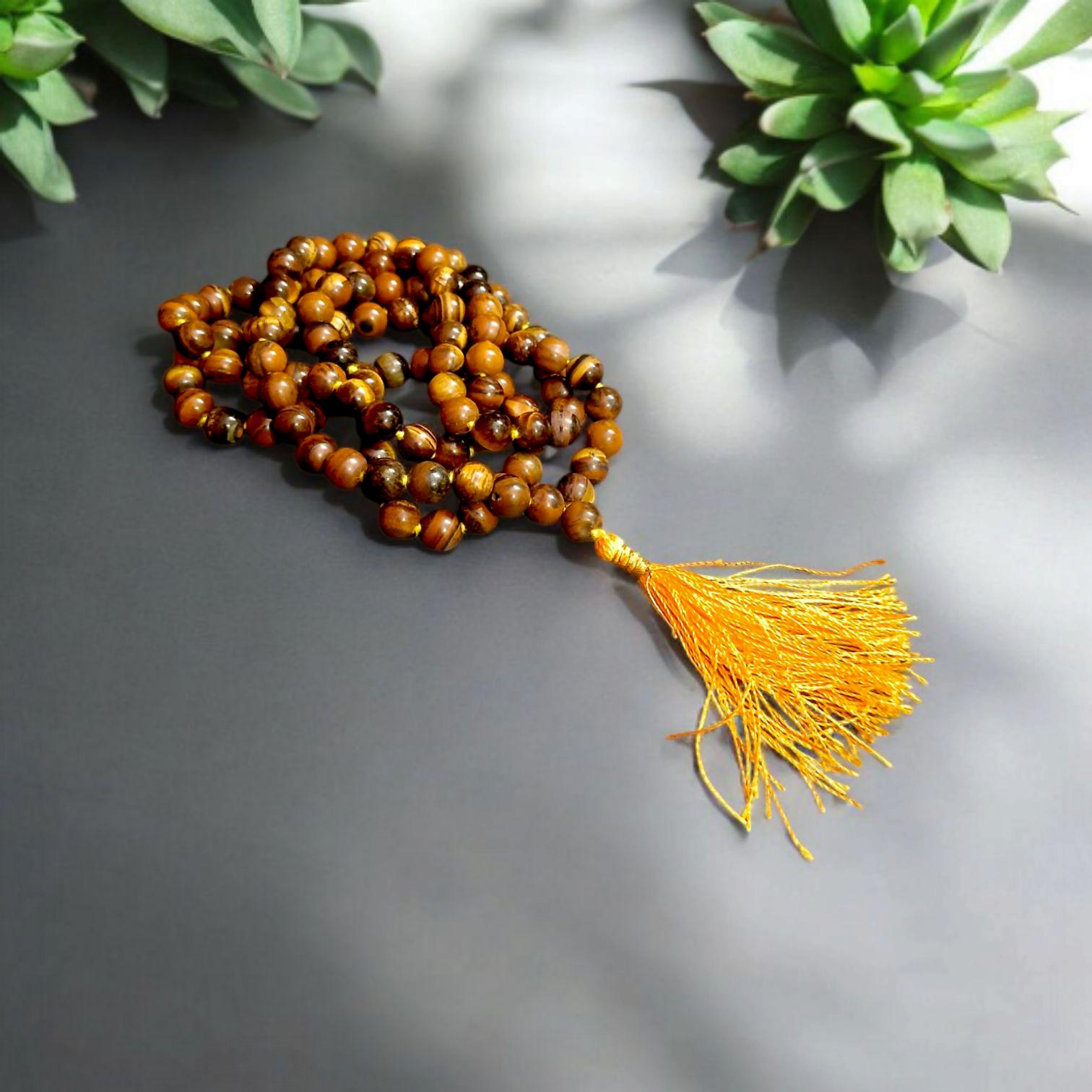 High-quality image of Tiger Eye Mala with natural golden-brown stone beads arranged in a traditional mala style