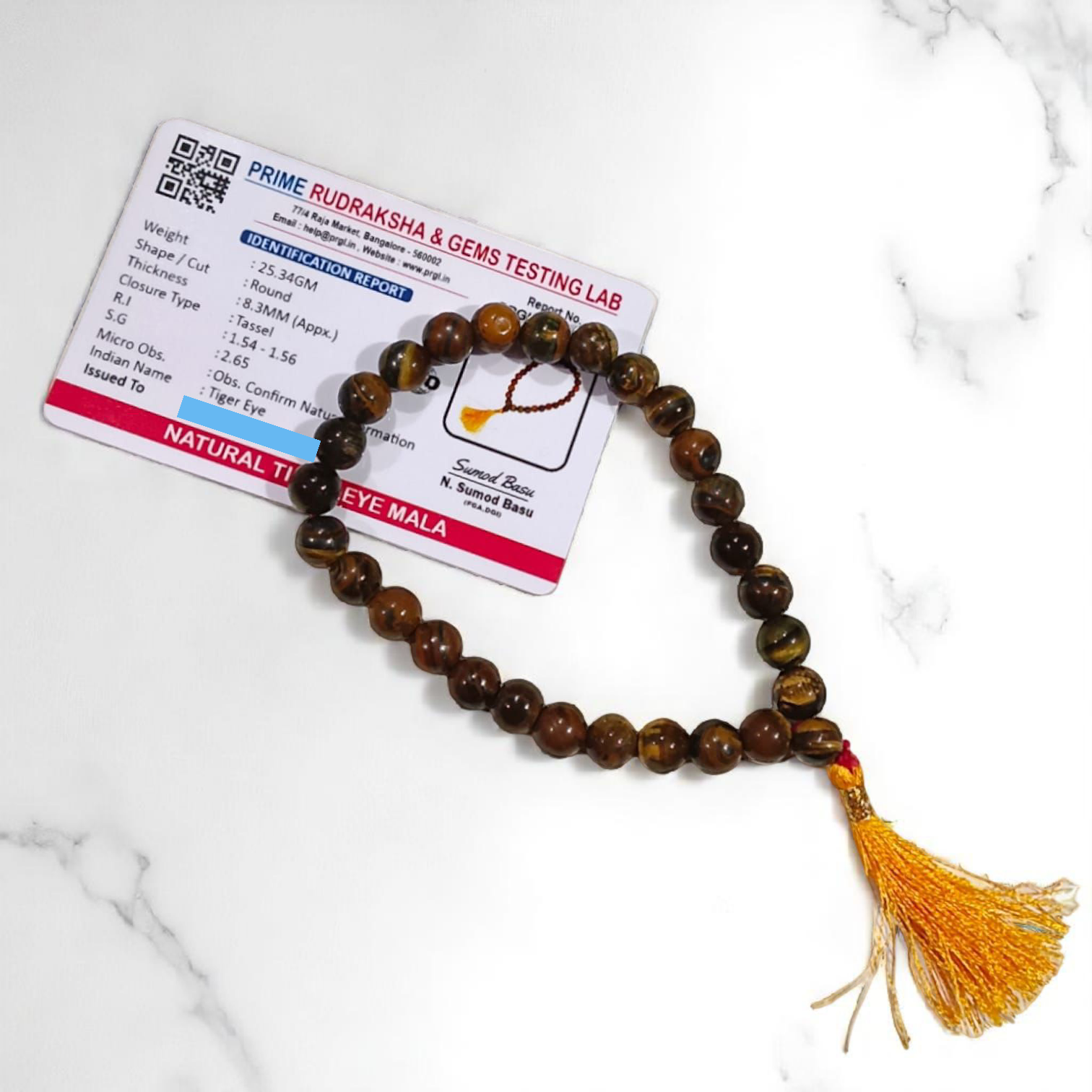 High-quality image of Tiger Eye Mala with natural golden-brown stone beads arranged in a traditional mala style
