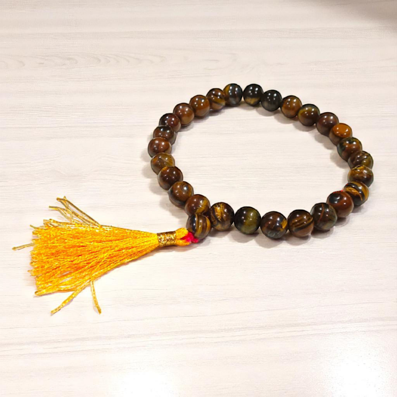High-quality image of Tiger Eye Mala with natural golden-brown stone beads arranged in a traditional mala style