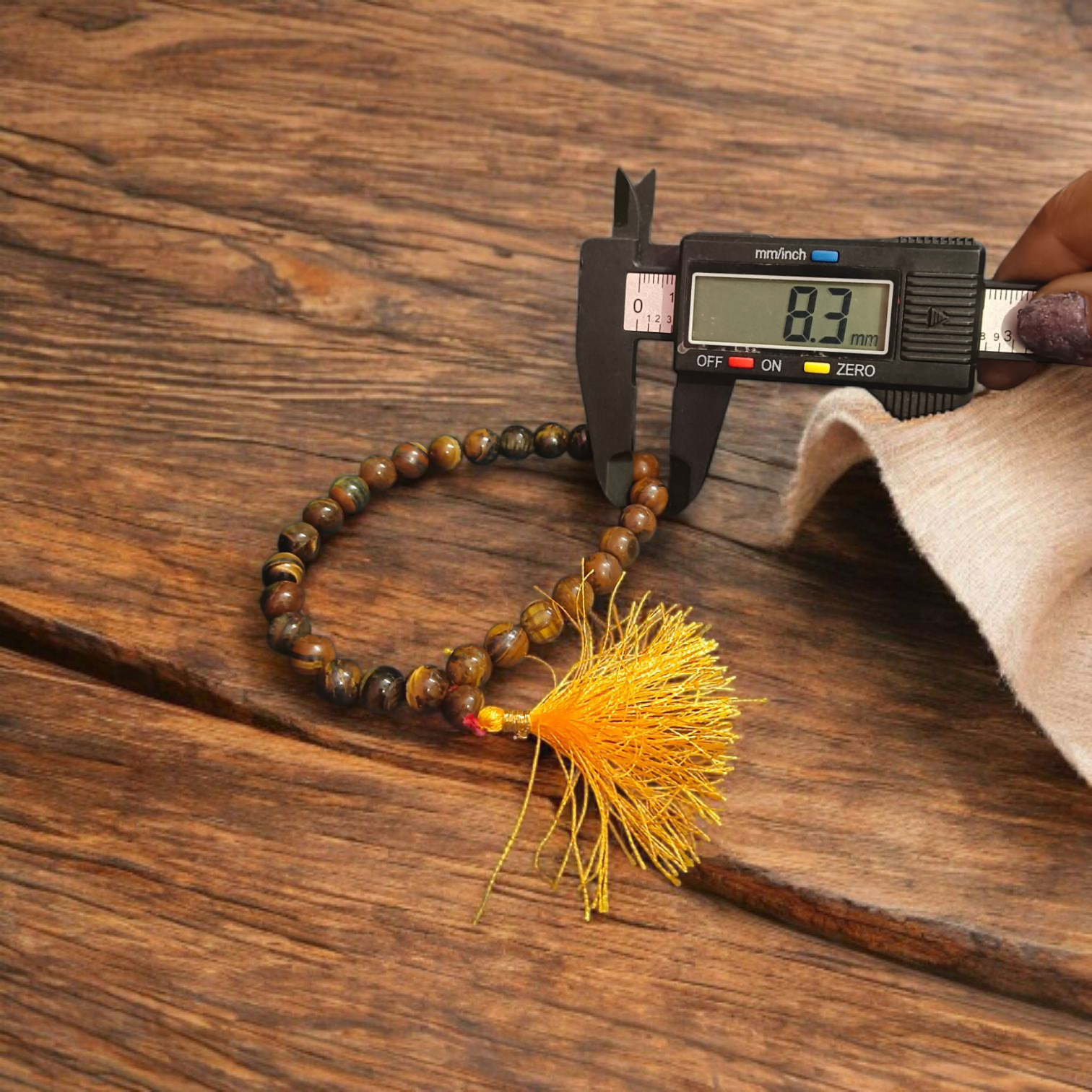 High-quality image of Tiger Eye Mala with natural golden-brown stone beads arranged in a traditional mala style