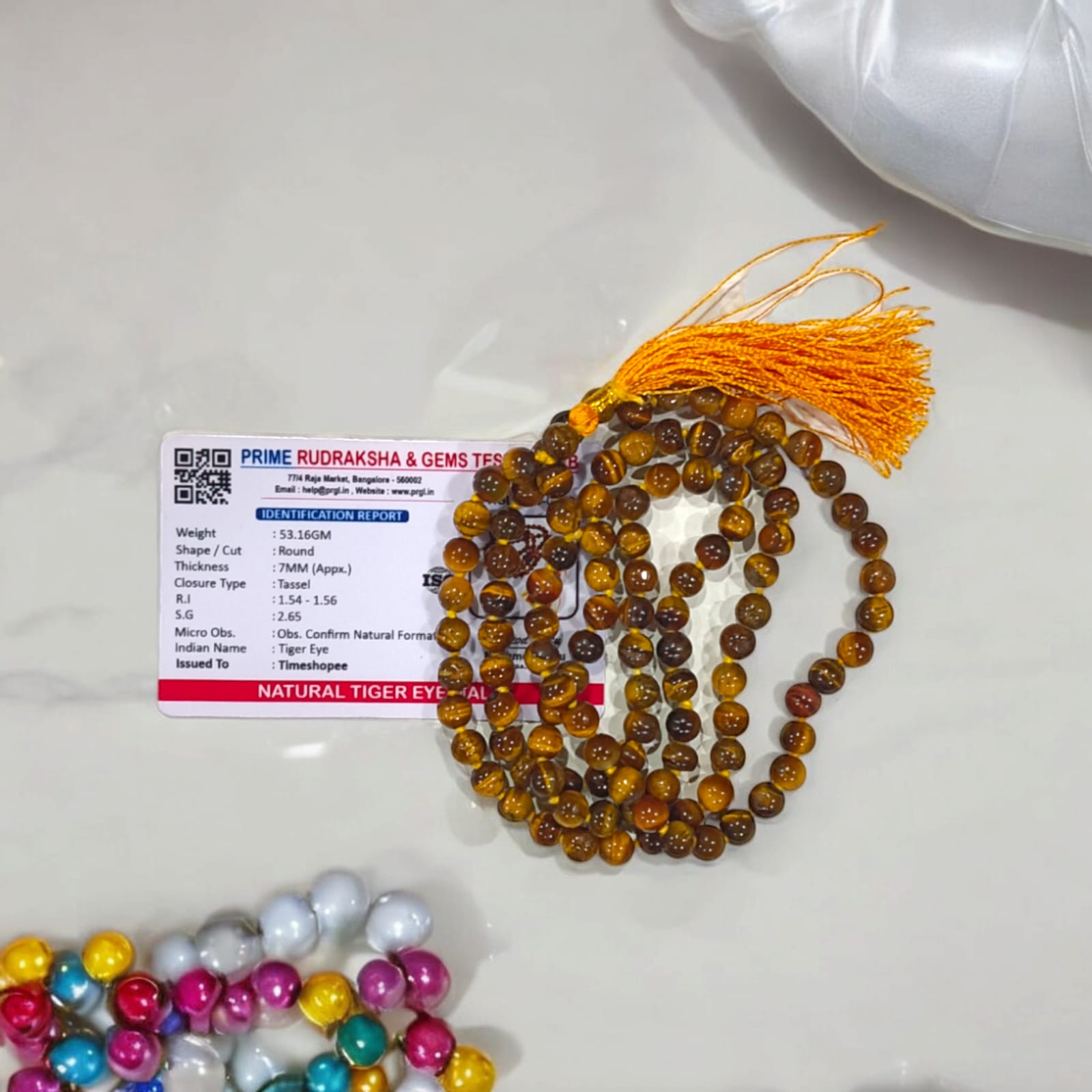 High-quality image of Tiger Eye Mala with natural golden-brown stone beads arranged in a traditional mala style