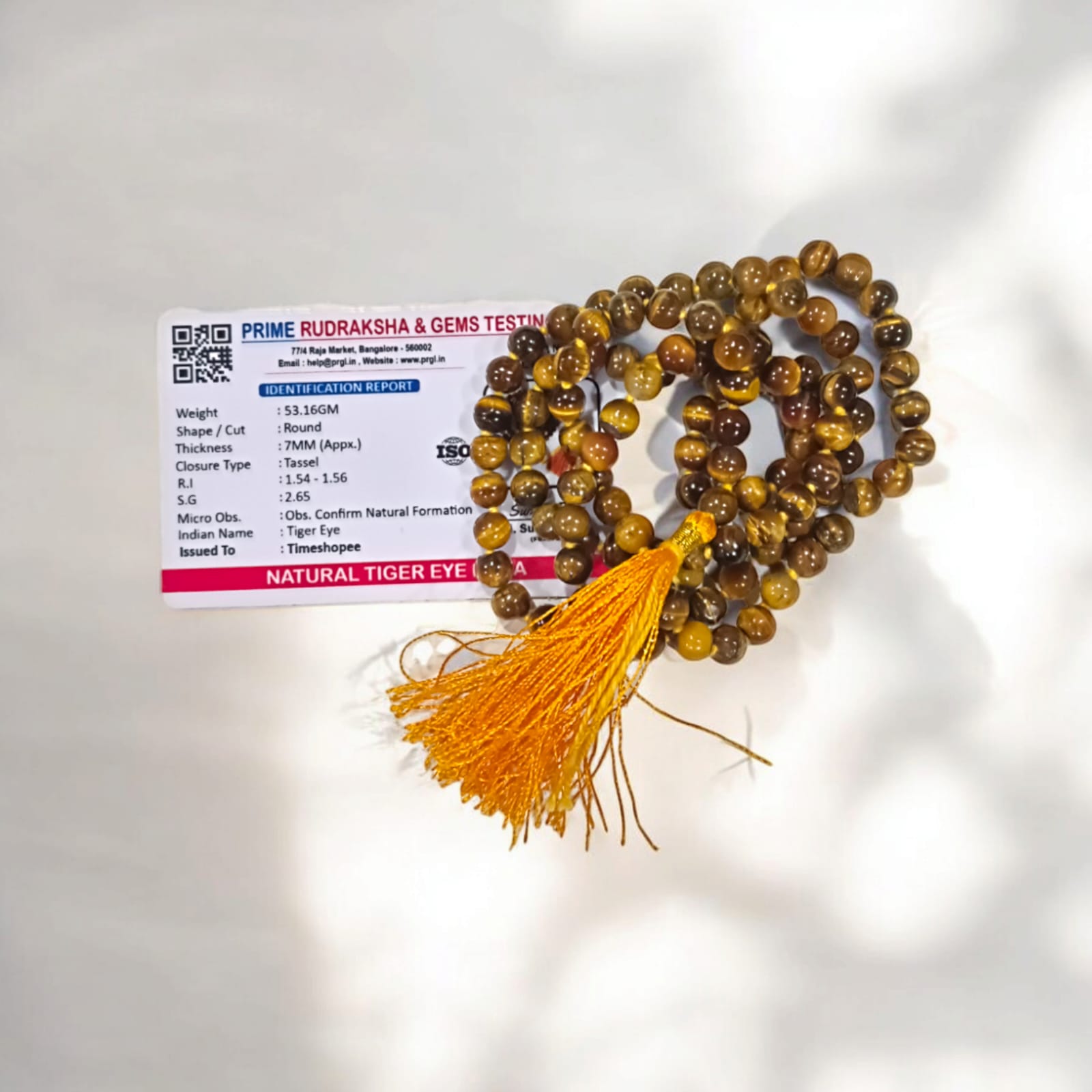 High-quality image of Tiger Eye Mala with natural golden-brown stone beads arranged in a traditional mala style