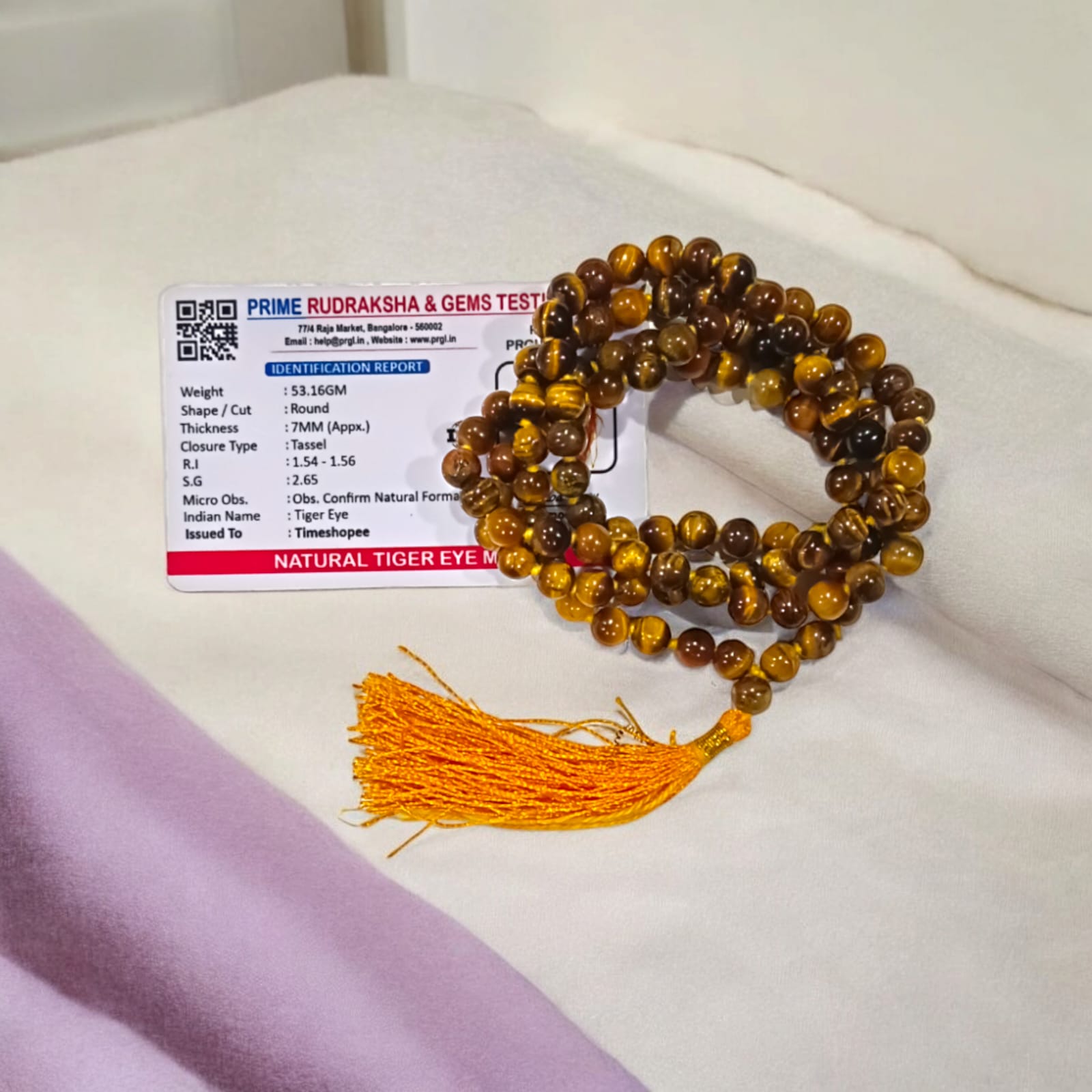 High-quality image of Tiger Eye Mala with natural golden-brown stone beads arranged in a traditional mala style