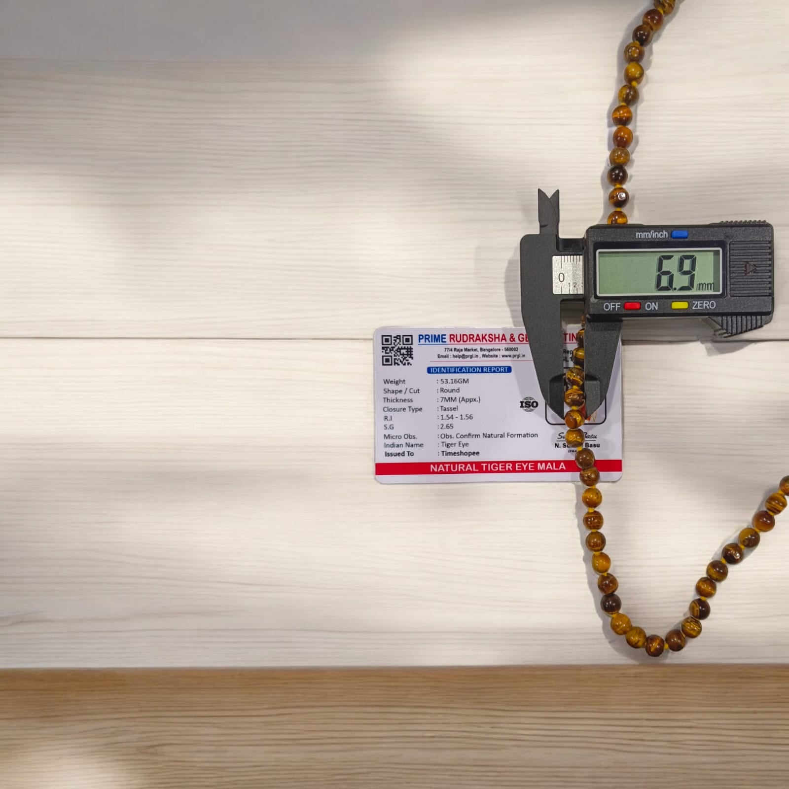 High-quality image of Tiger Eye Mala with natural golden-brown stone beads arranged in a traditional mala style