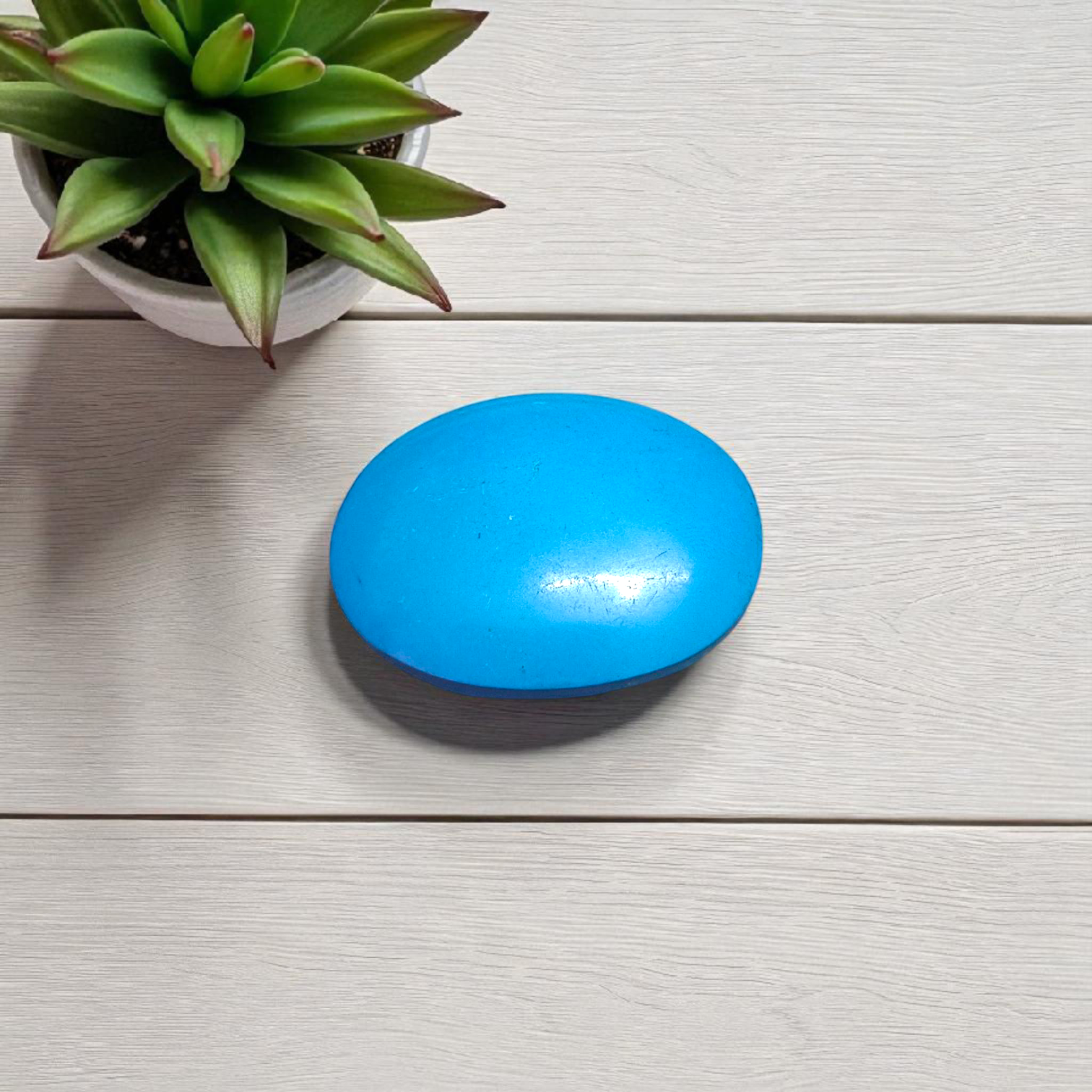 High-quality image of a natural turquoise (Firoza) gemstone with blue-green hues, polished surface, used for healing, confidence, and spiritual purposes