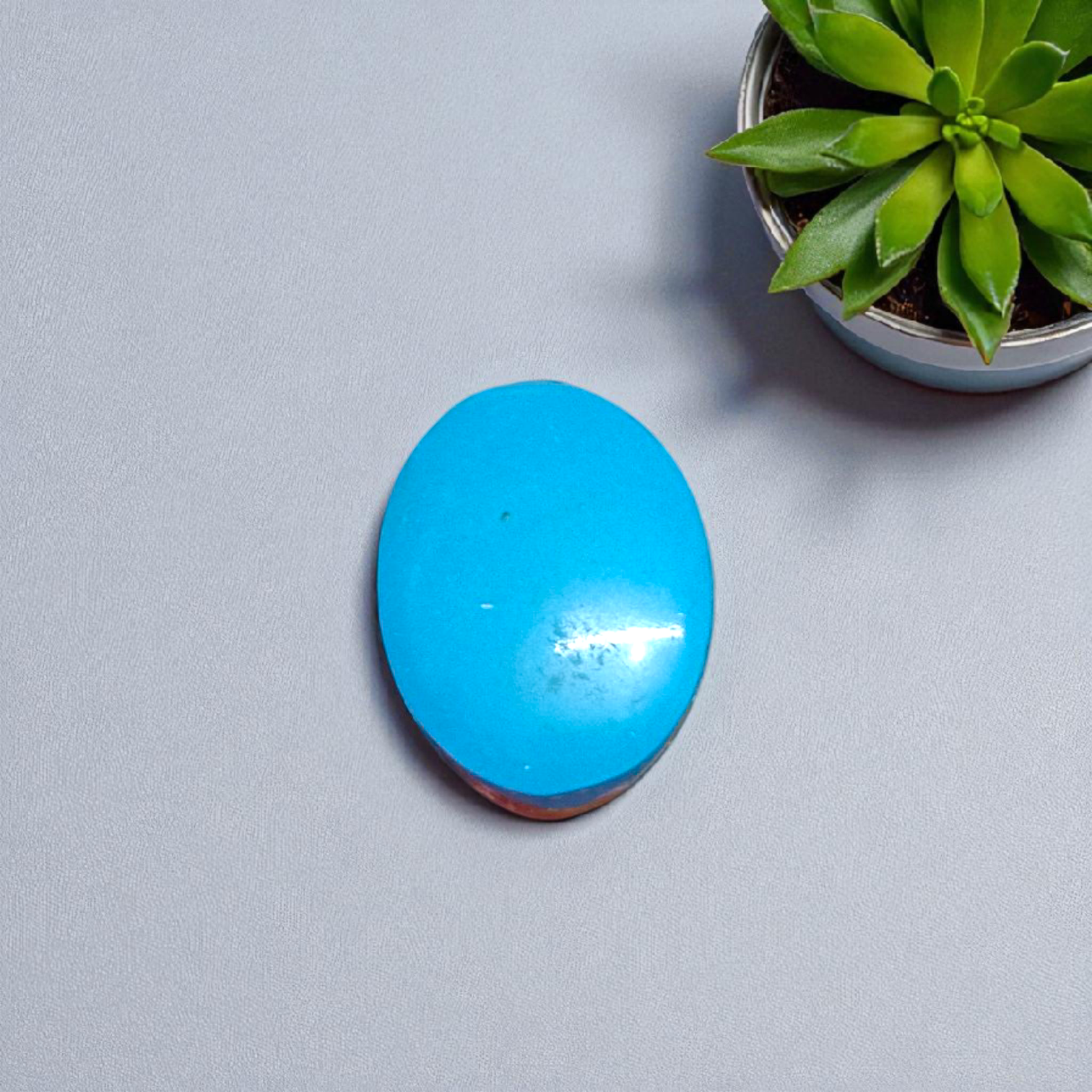 High-quality image of a natural turquoise (Firoza) gemstone with blue-green hues, polished surface, used for healing, confidence, and spiritual purposes