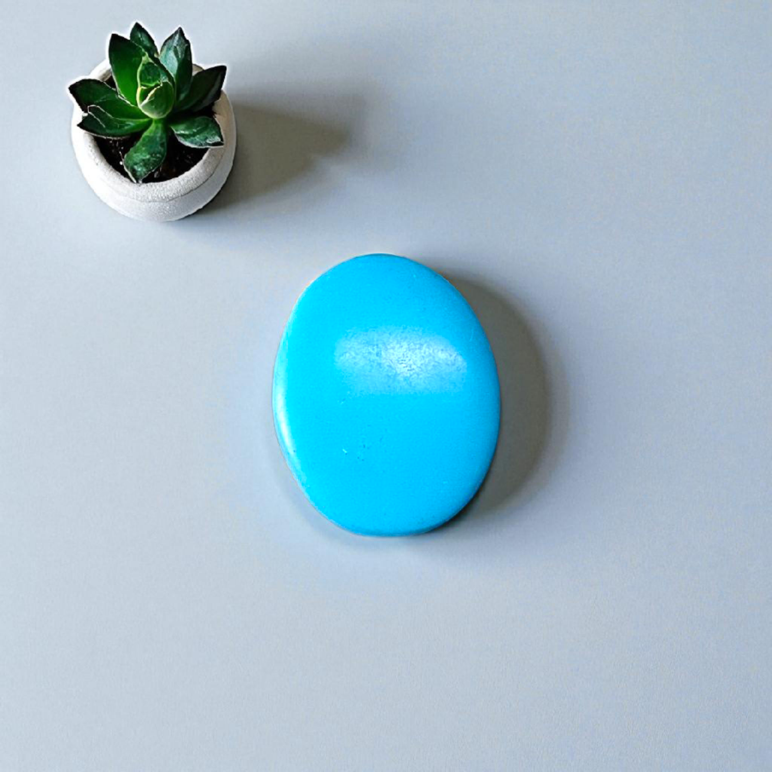 High-quality image of a natural turquoise (Firoza) gemstone with blue-green hues, polished surface, used for healing, confidence, and spiritual purposes