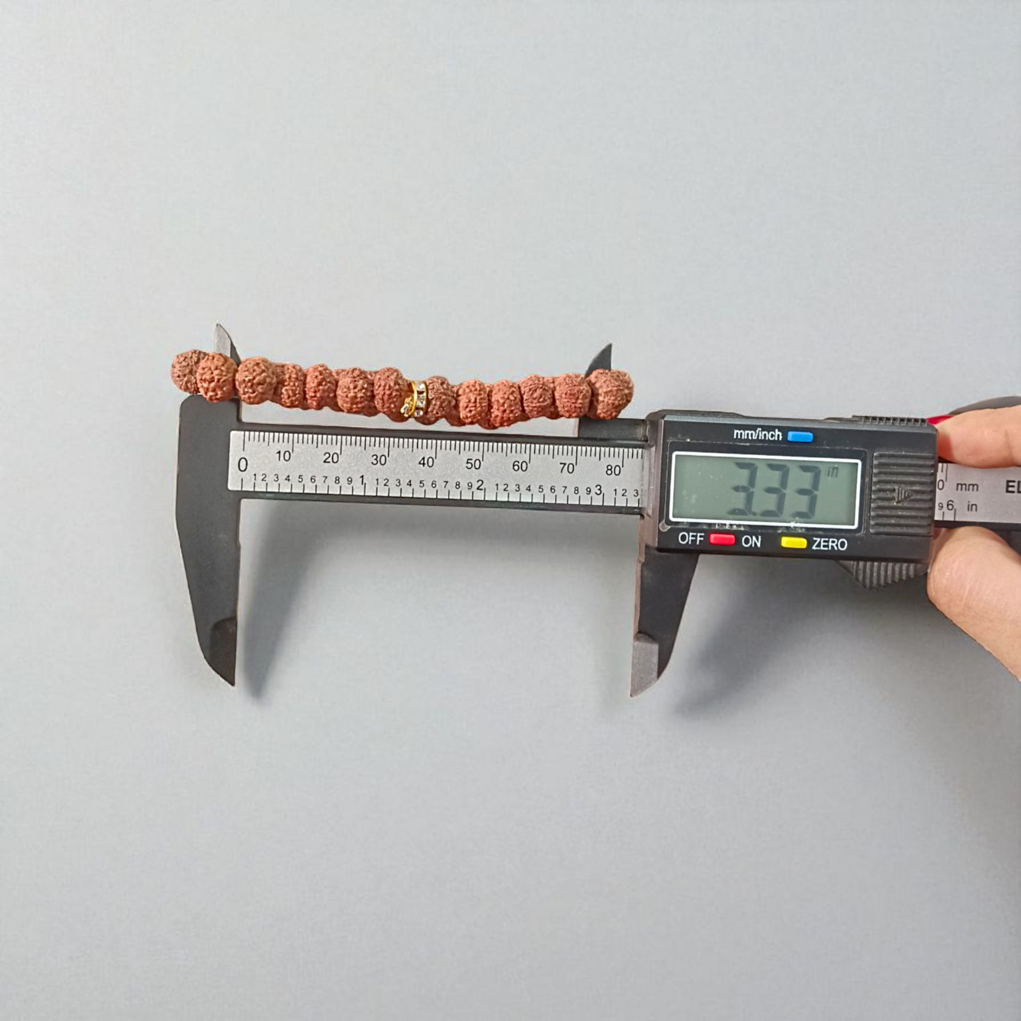 Image of 7 Mukhi Rudraksha Bracelet with 9mm natural brown beads, arranged in a stretchable circular form, set against a neutral background