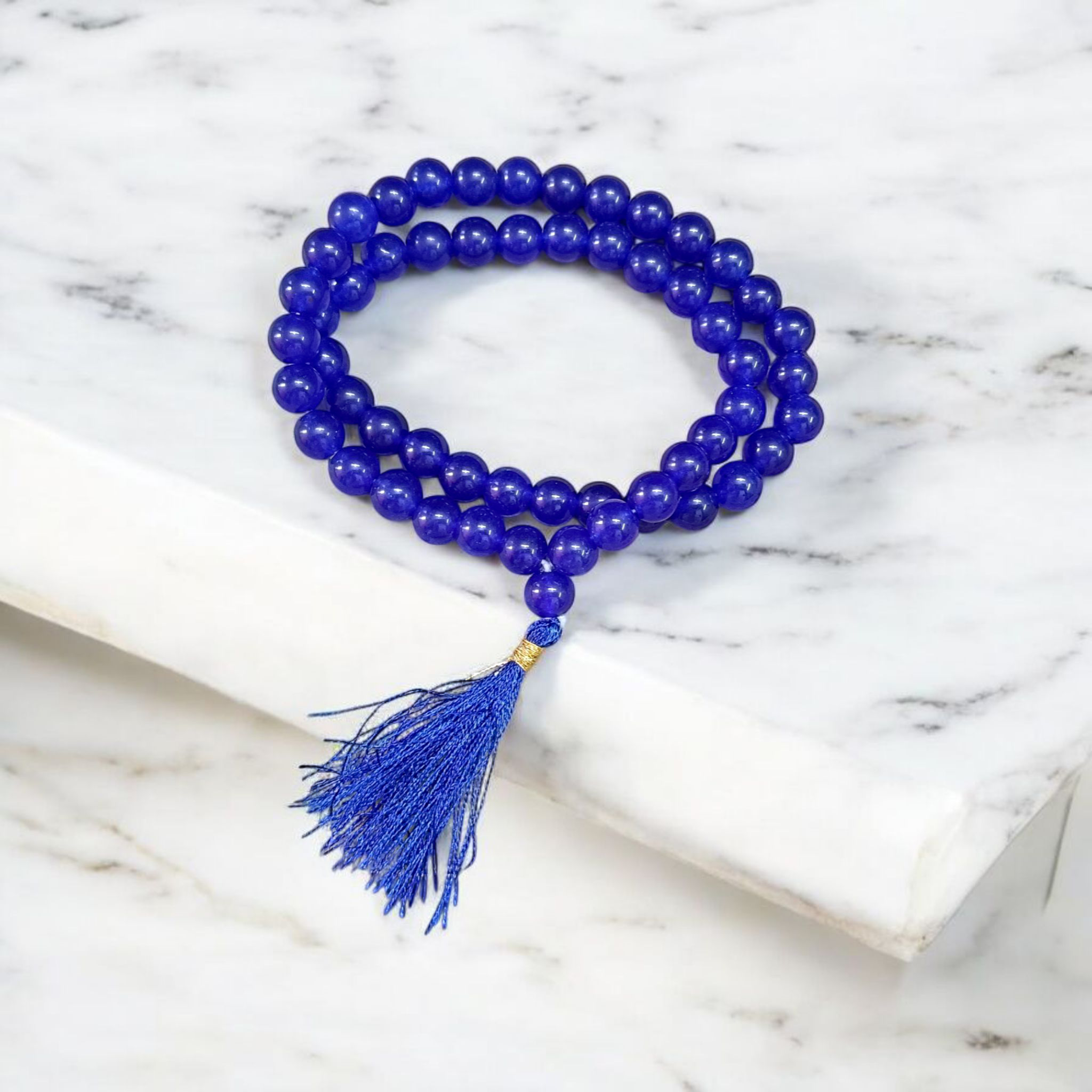 Image of Blue Agate Mala featuring 54+1 polished 8mm blue beads, neatly strung for mantra chanting, meditation, and spiritual growth