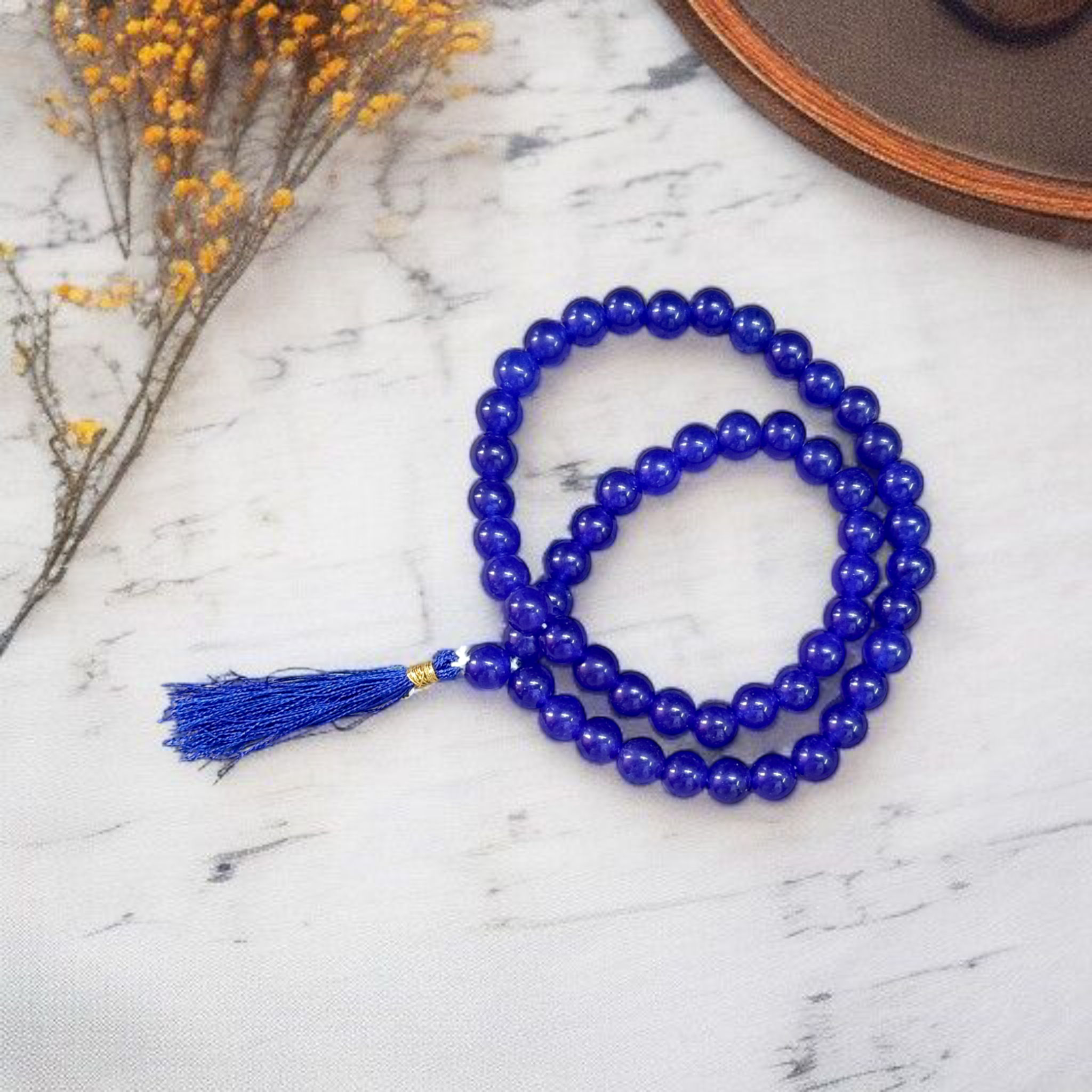 Image of Blue Agate Mala featuring 54+1 polished 8mm blue beads, neatly strung for mantra chanting, meditation, and spiritual growth