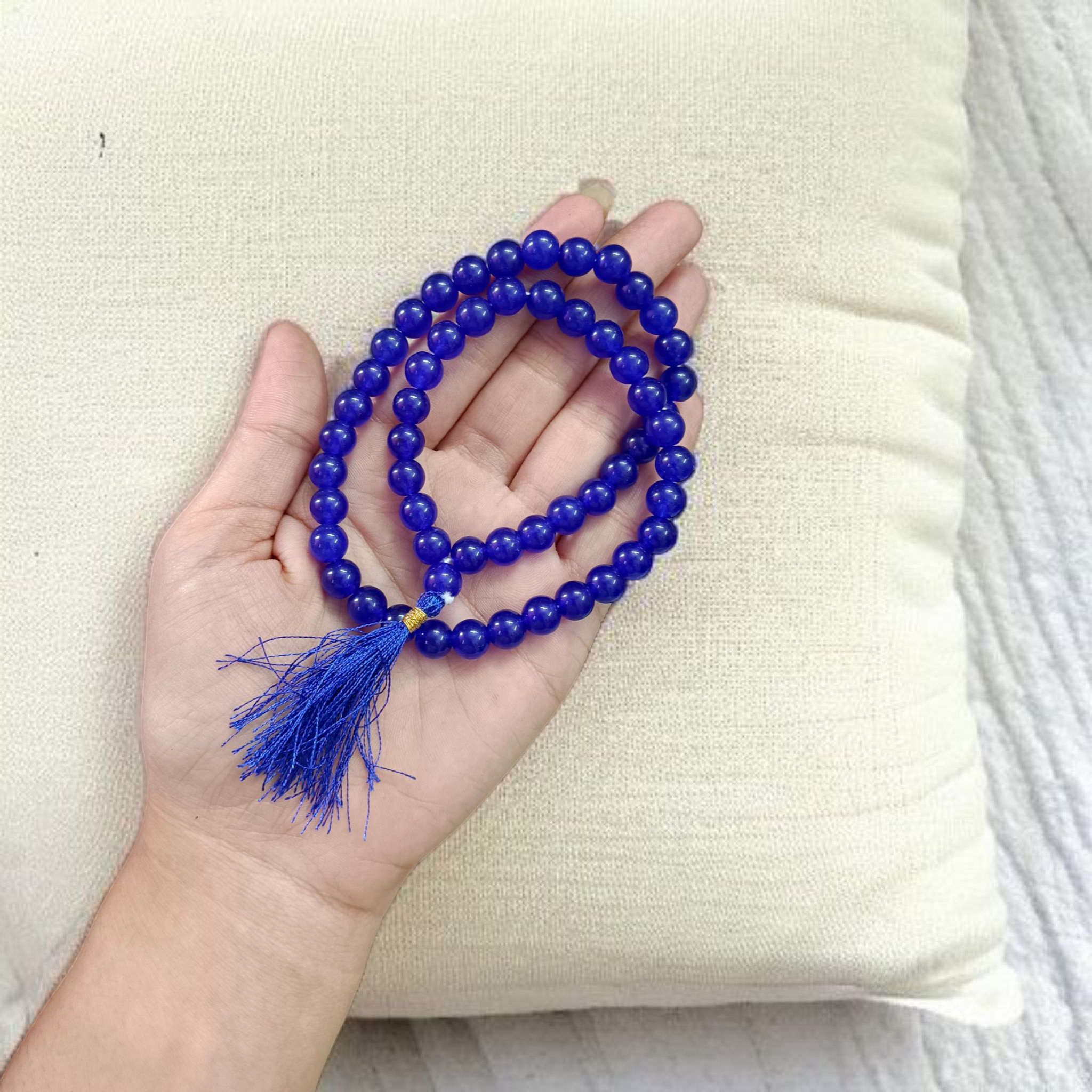 Image of Blue Agate Mala featuring 54+1 polished 8mm blue beads, neatly strung for mantra chanting, meditation, and spiritual growth