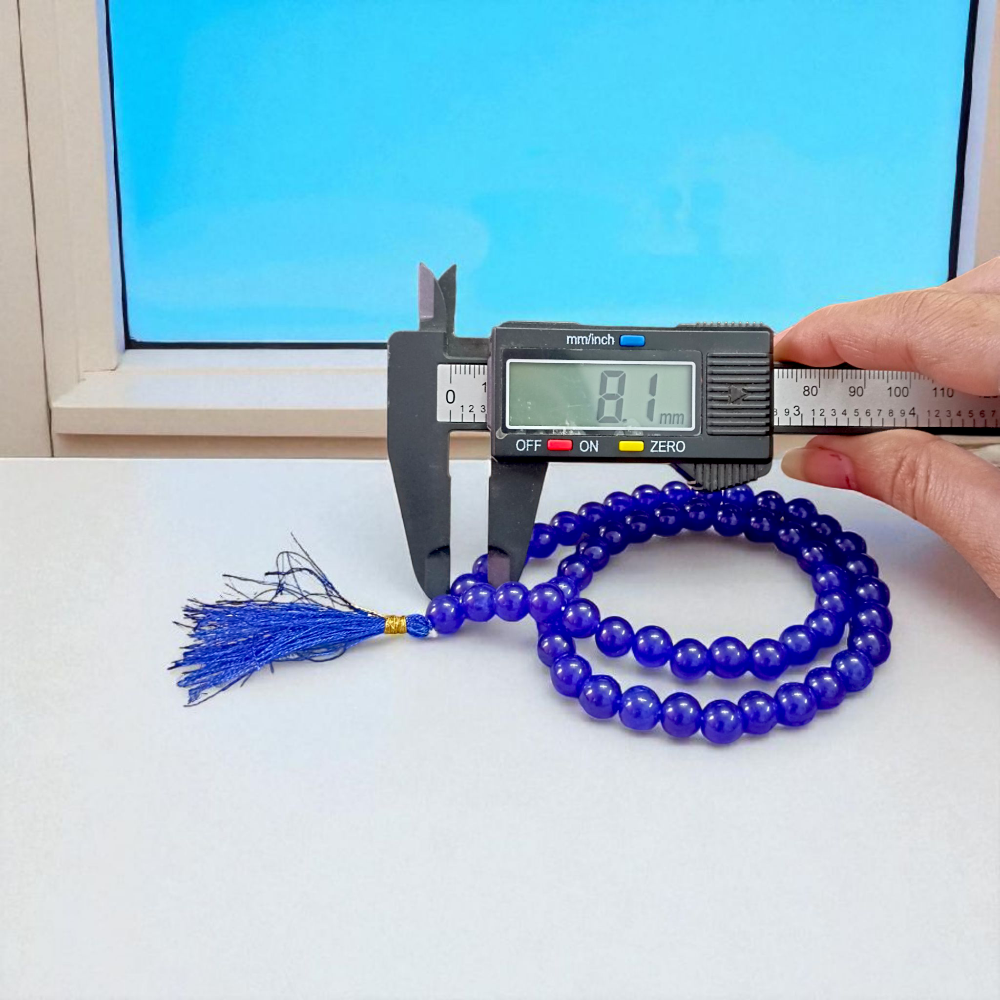 Image of Blue Agate Mala featuring 54+1 polished 8mm blue beads, neatly strung for mantra chanting, meditation, and spiritual growth