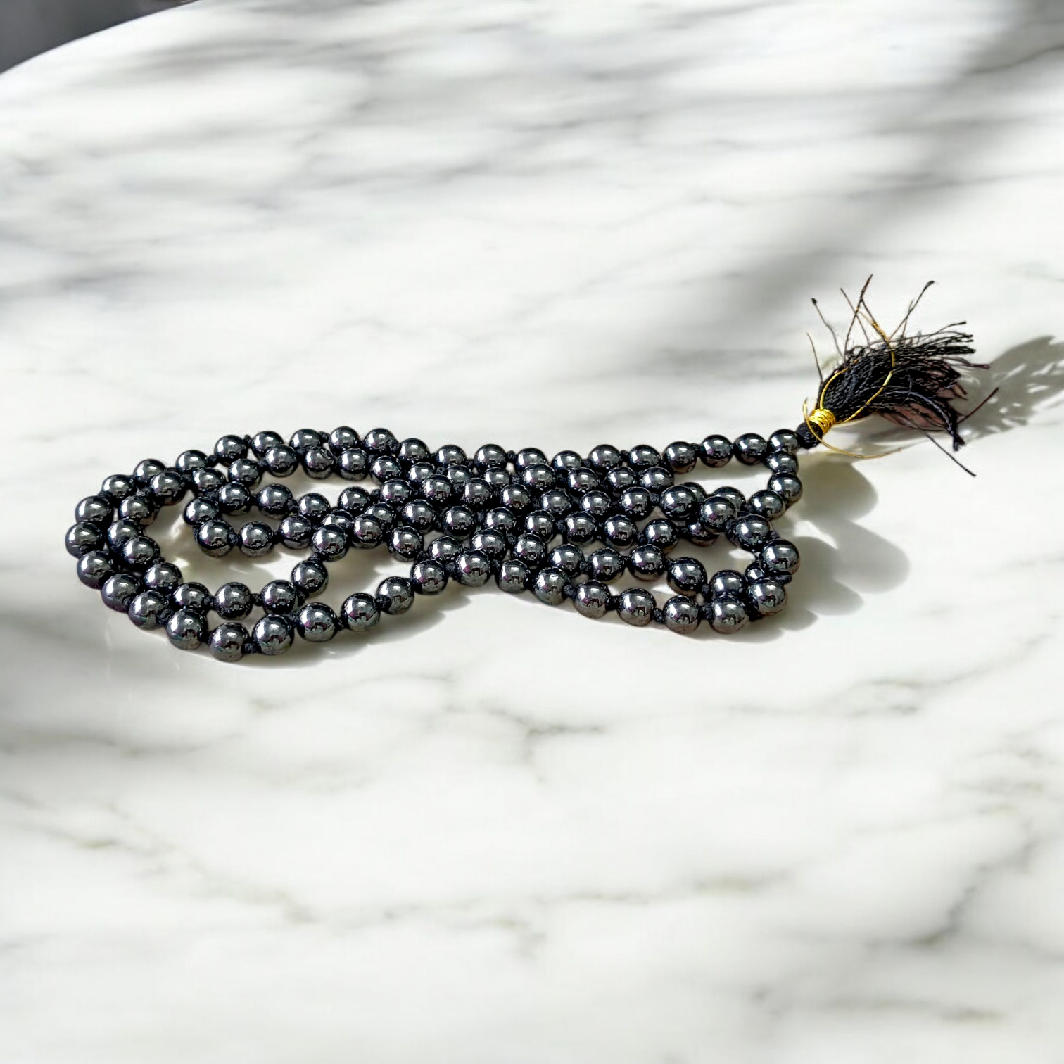 Image of Magnet Mala made of 108+1 magnetic beads, 8mm each, strung in traditional style, used for meditation, energy balancing, and stylish spiritual wear